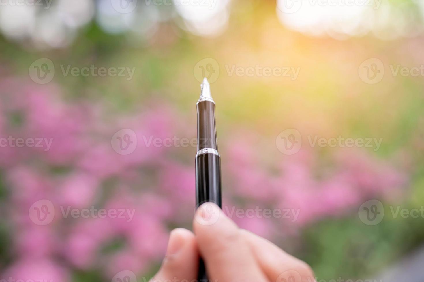 Woman taking notes in a white flower garden photo