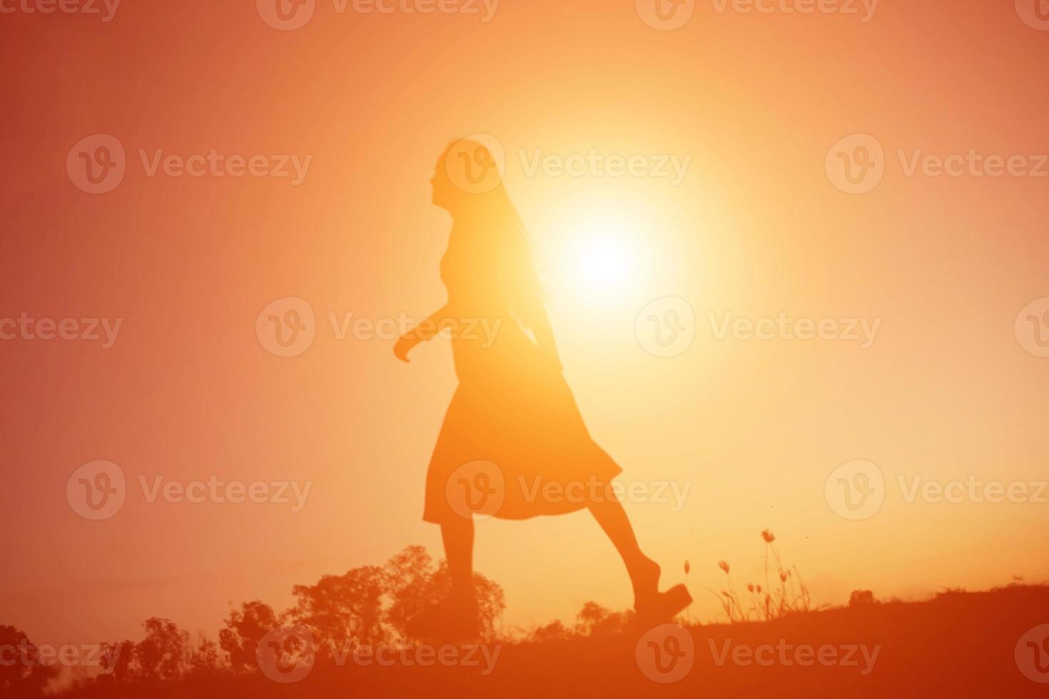 silhouette of a young woman standing alone photo