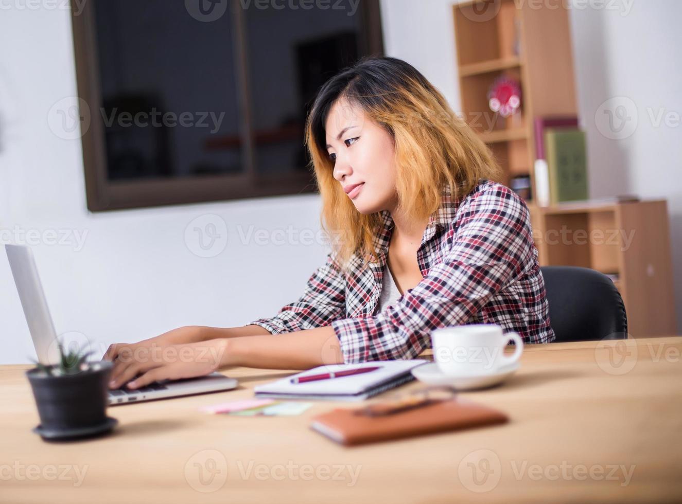 Business Woman Writing with pen in notepad on workplace. photo