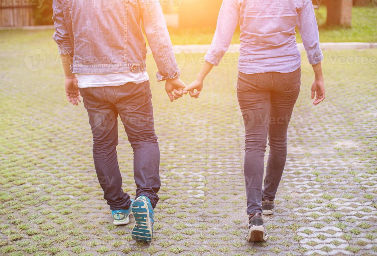 A young couple holding hands. In Nature sunrise photo