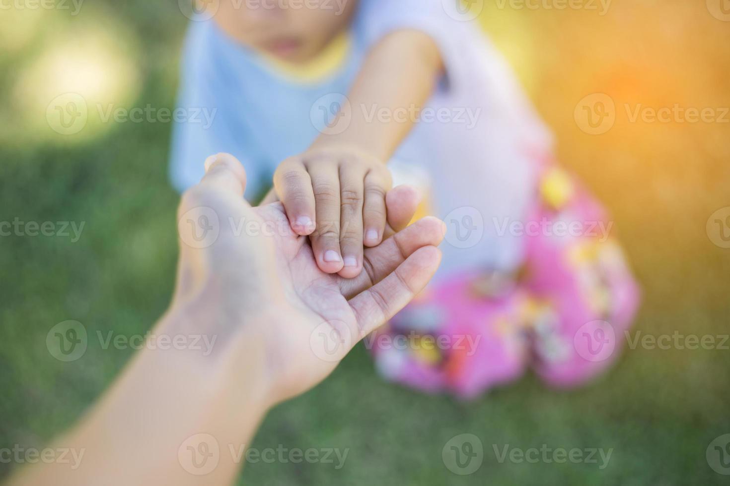 Happy boy child is smiling enjoying adopted life. Portrait of young boy in nature, park or outdoors. Concept of happy family or successful adoption or parenting. photo