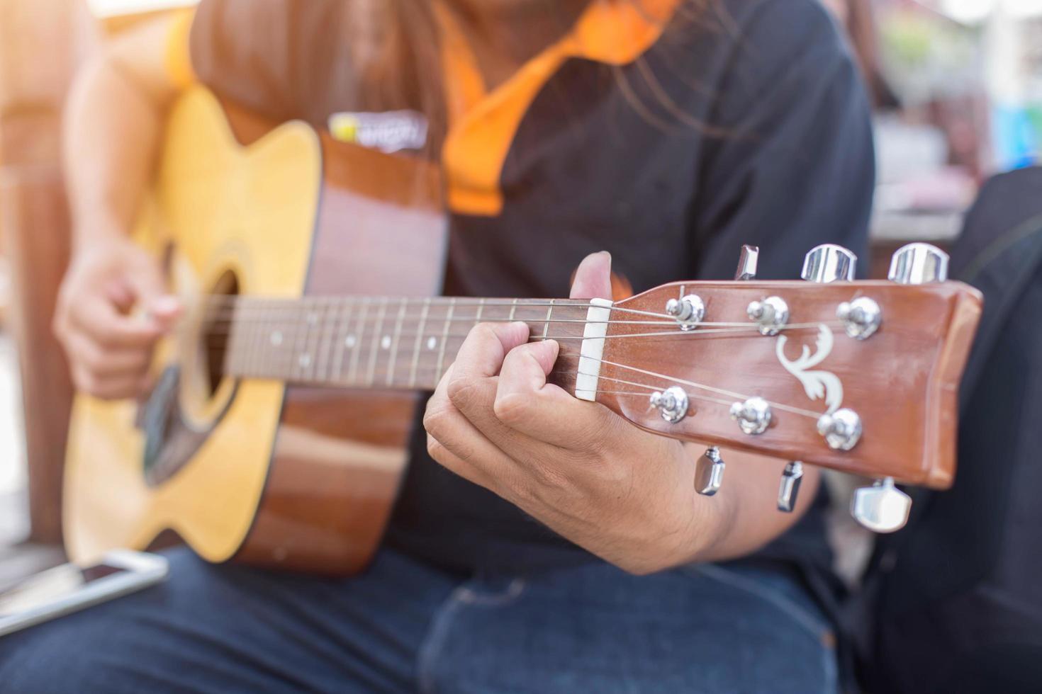 Close up of man hand playing guitar photo