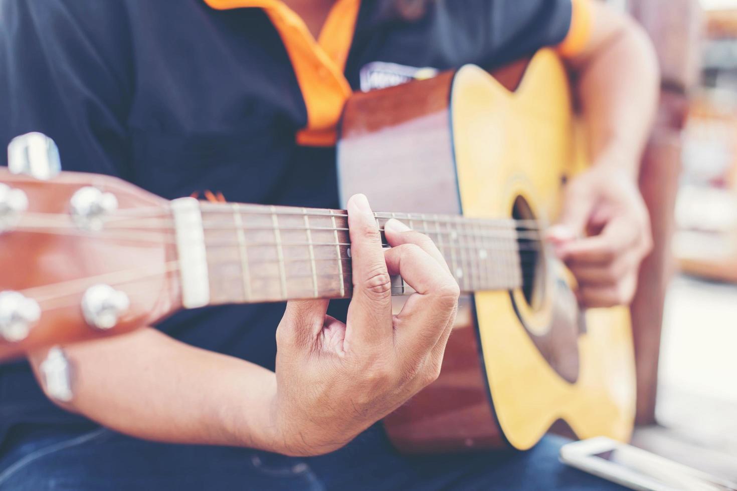 Close up of man hand playing guitar photo