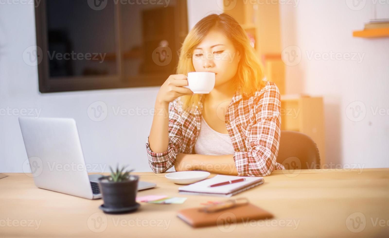 business woman writing something on notepad in office. photo