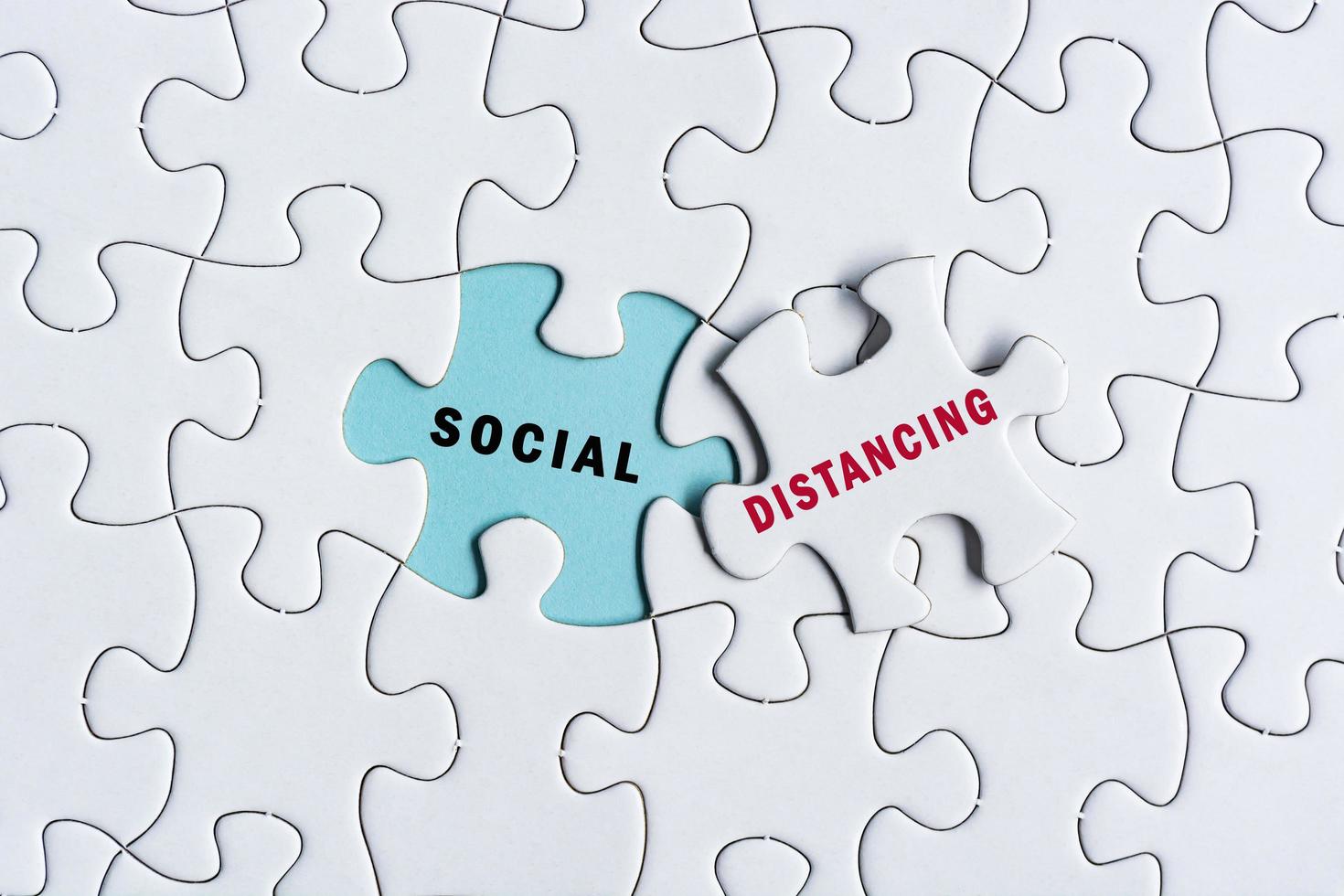 Social distancing text on Jigsaw Puzzle. Pandemic concept photo