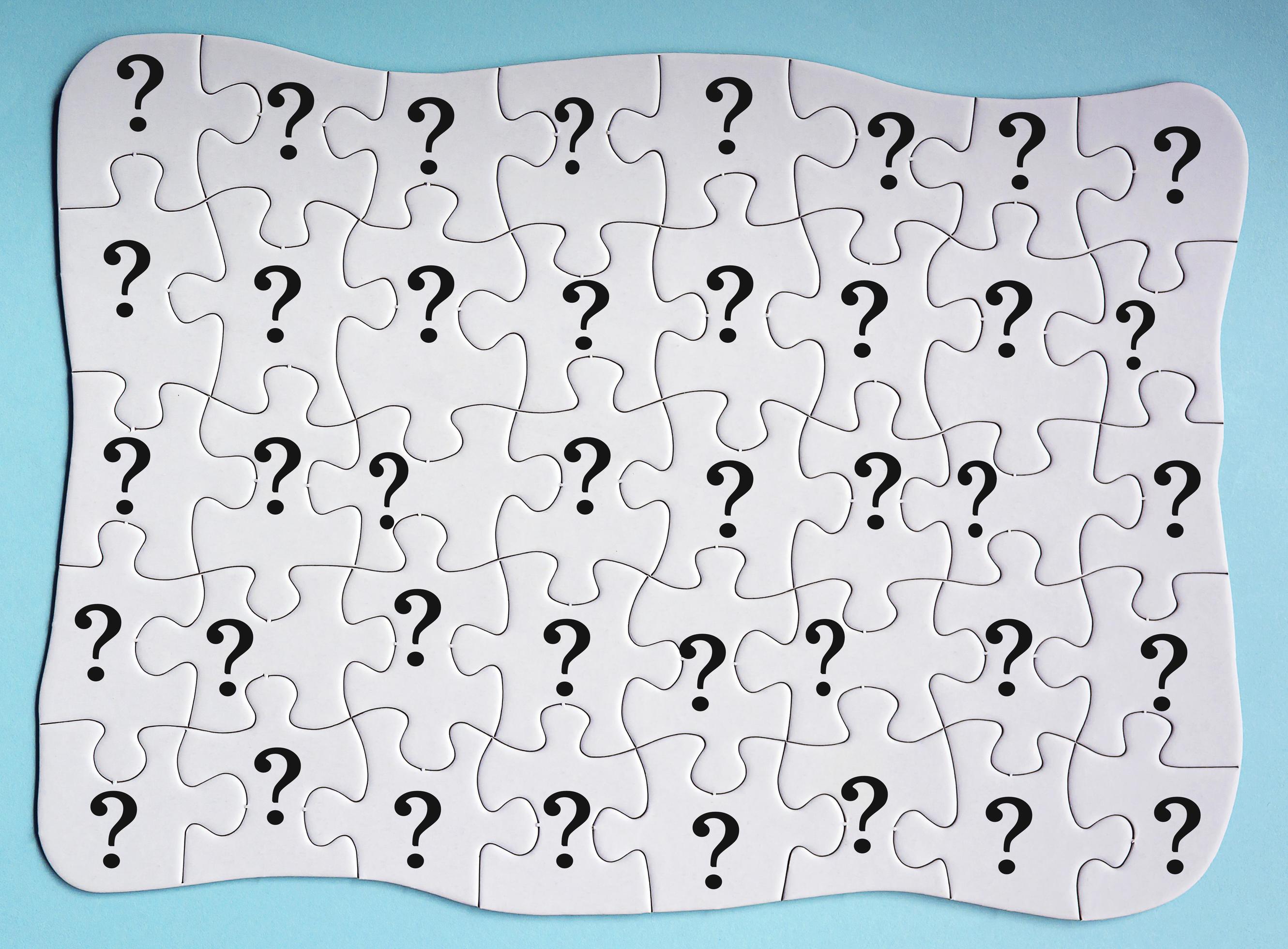 Set of 40 puzzle pieces with question mark isolated on blue background