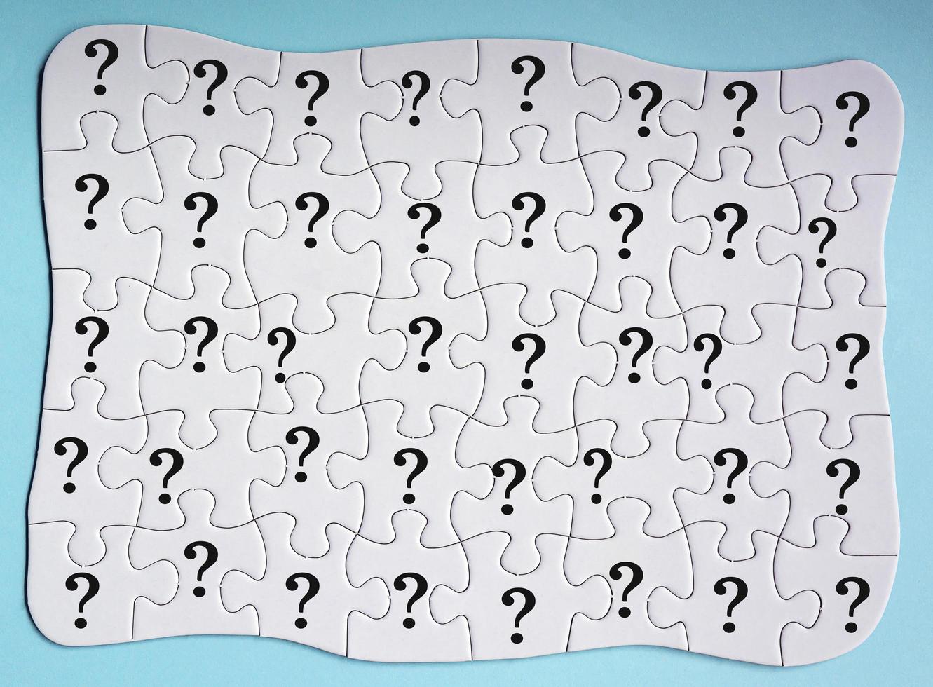 Set of 40 puzzle pieces with question mark isolated on blue background. photo