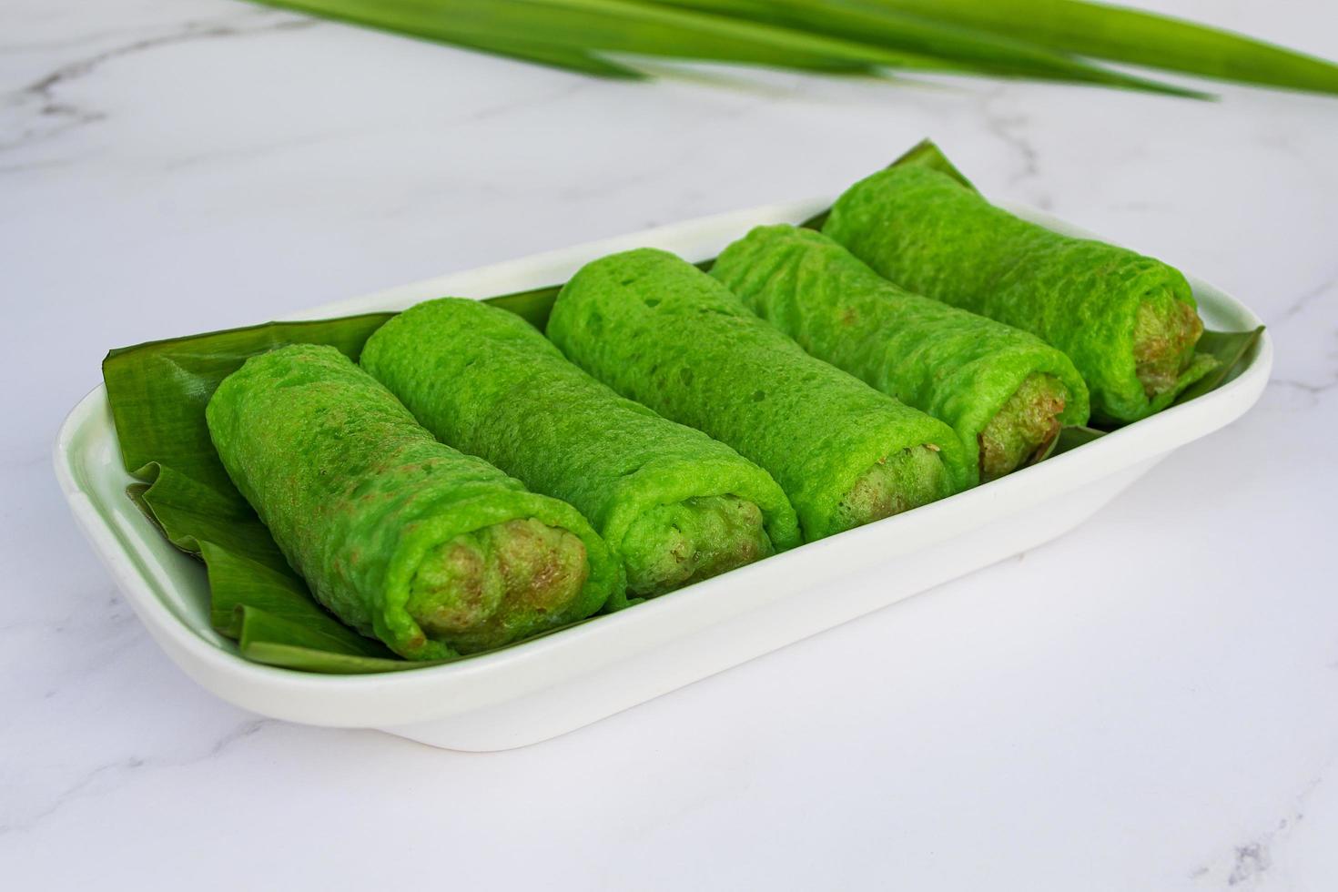 Malaysia sweet dessert with coconut known as kuih ketayap photo