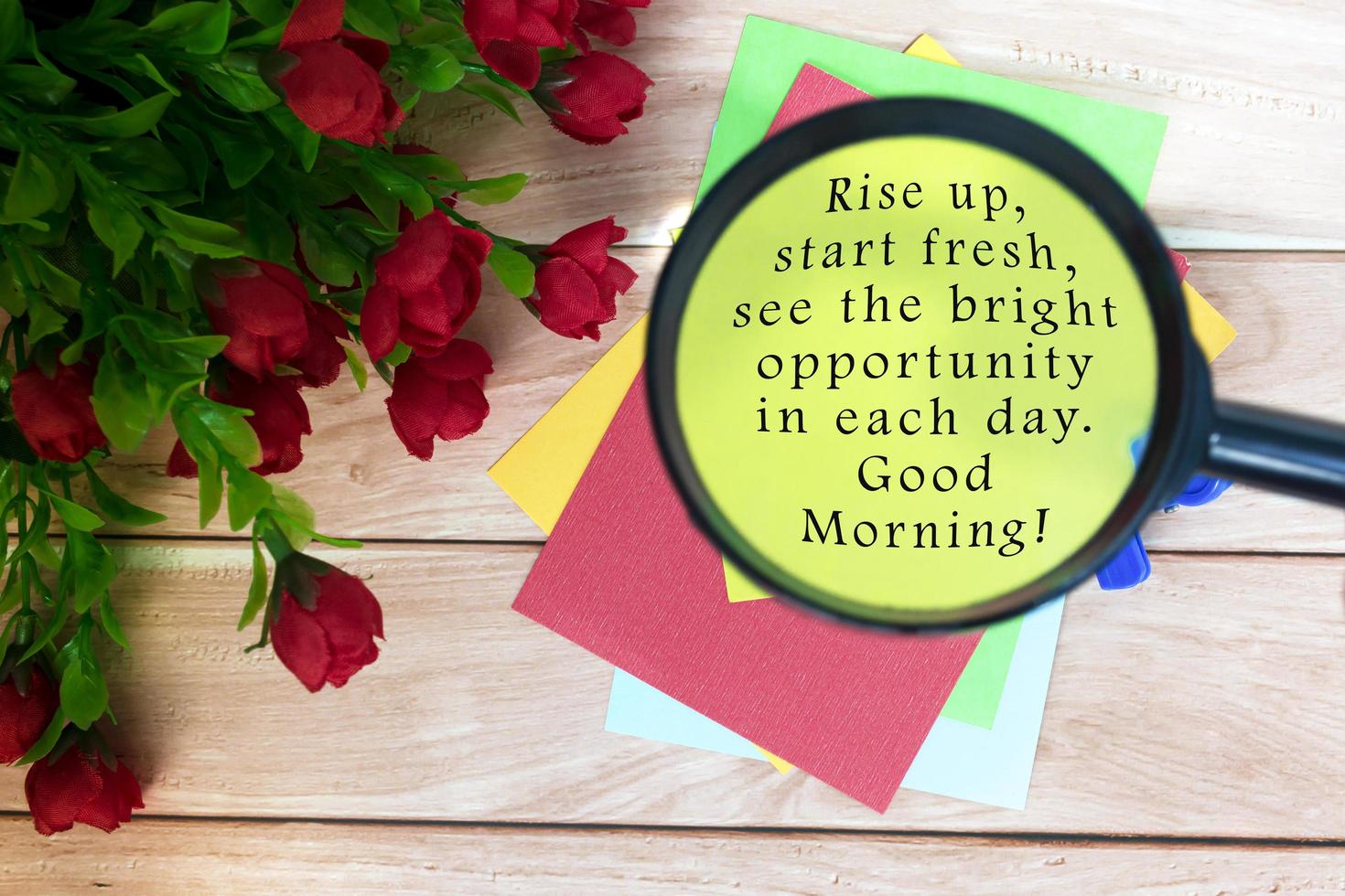 Motivational quote on written on colorful notepad with magnifying glass. photo