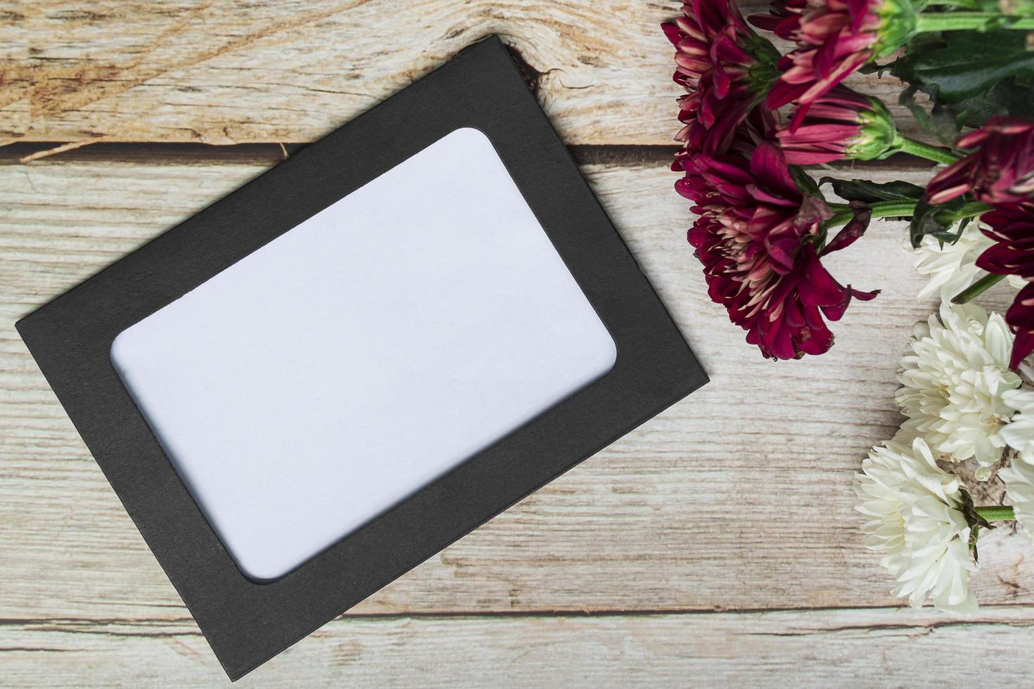 Chalkboard frame on wooden desk. Directly above, flat lay, copy space. photo