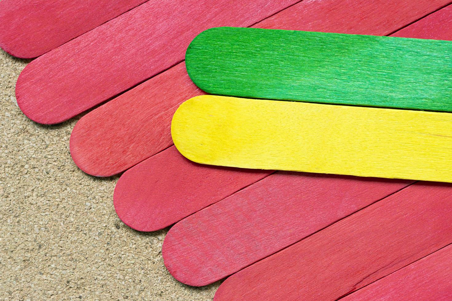 yellow and red color wooden stick on wooden desk.Directly above. Copy space. photo