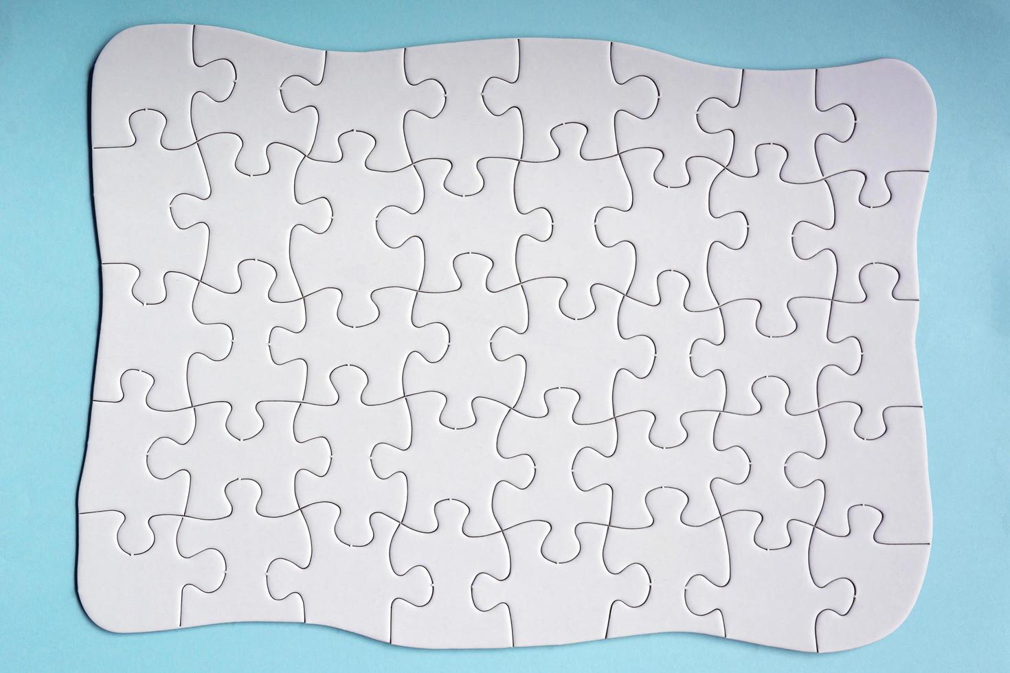 Set of 40 puzzle pieces isolated on blue background. Flat lay. Directly above. photo