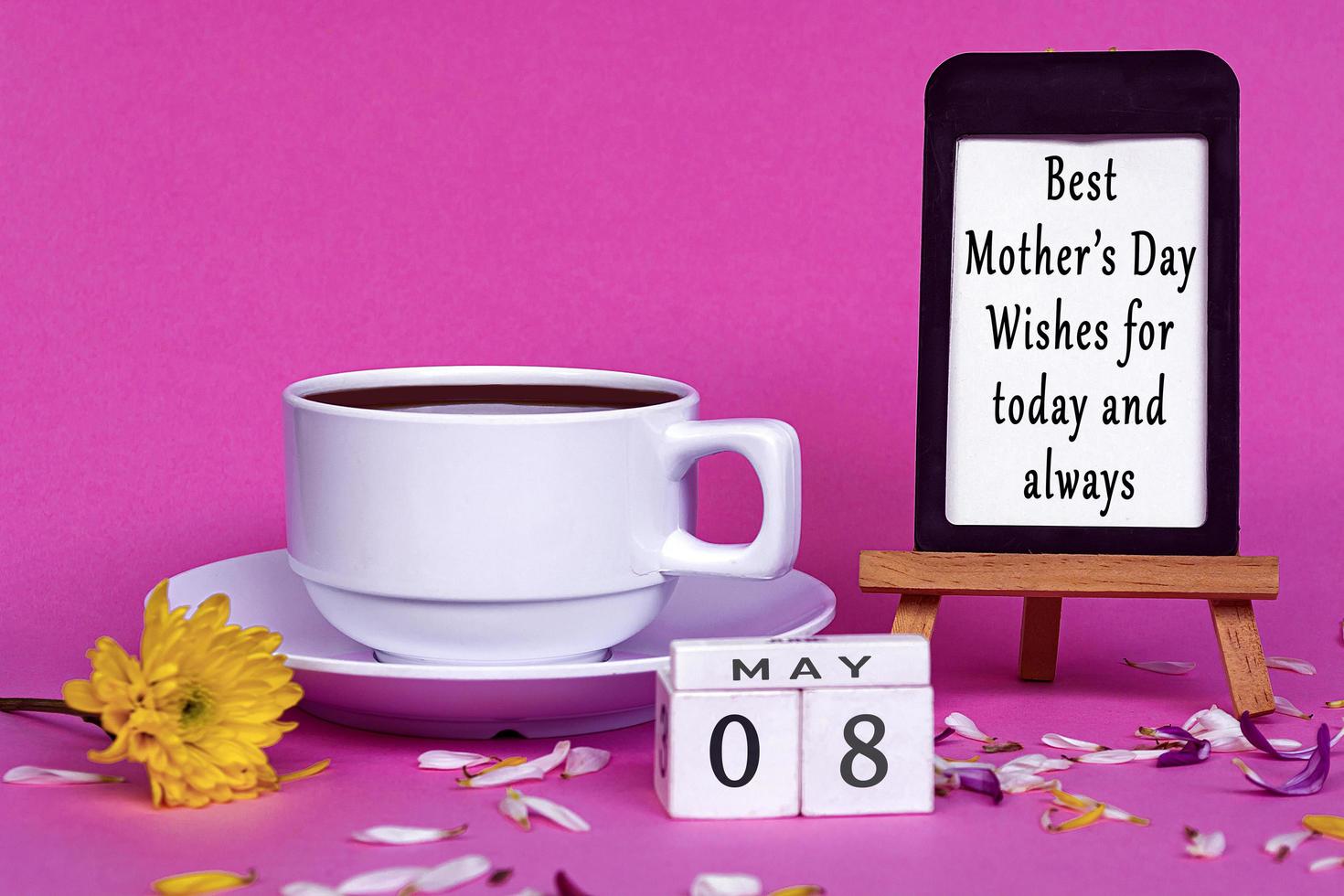 Mother's day wishes with wooden block cube on pink background. photo