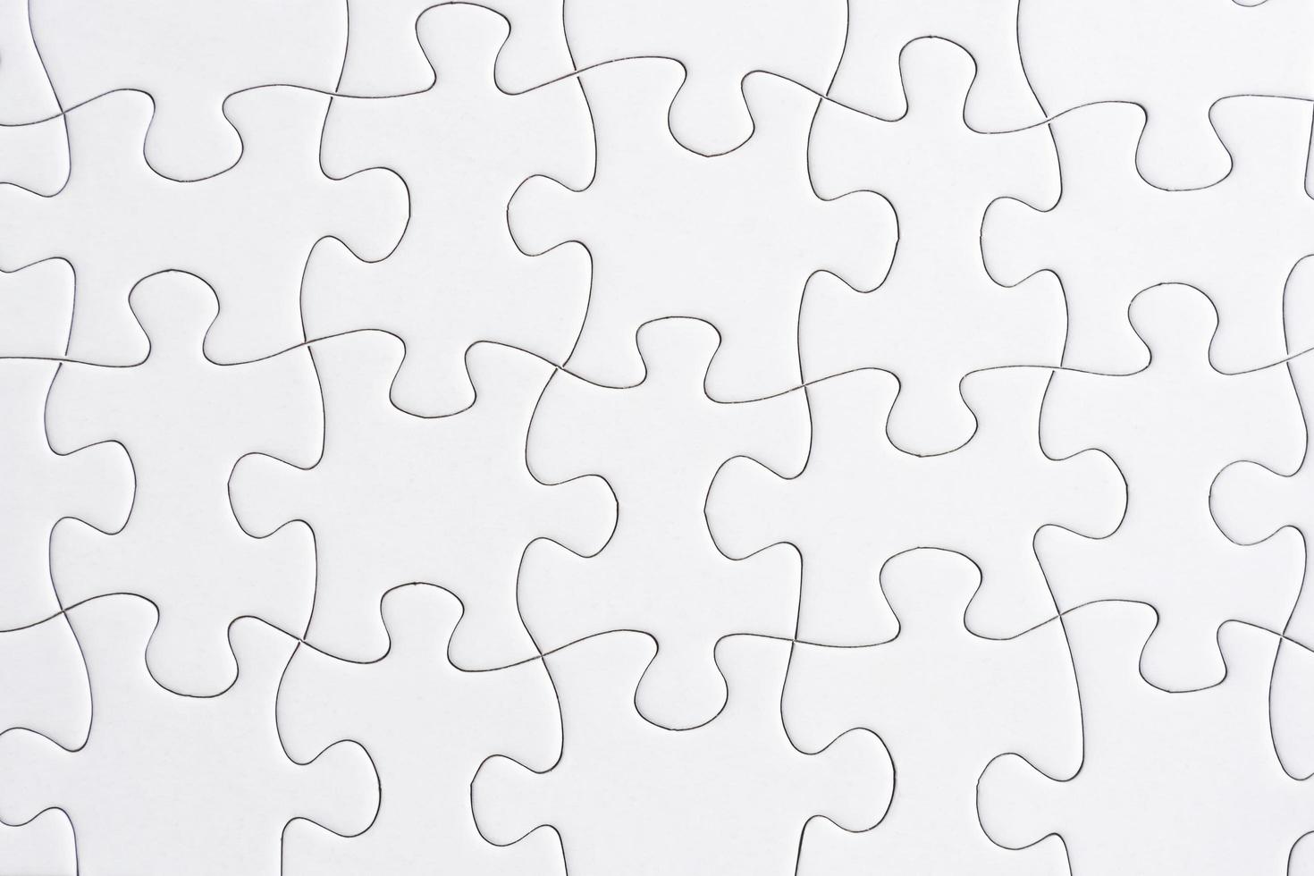 Puzzle pieces isolated on blue background. Flat lay. Directly above. photo