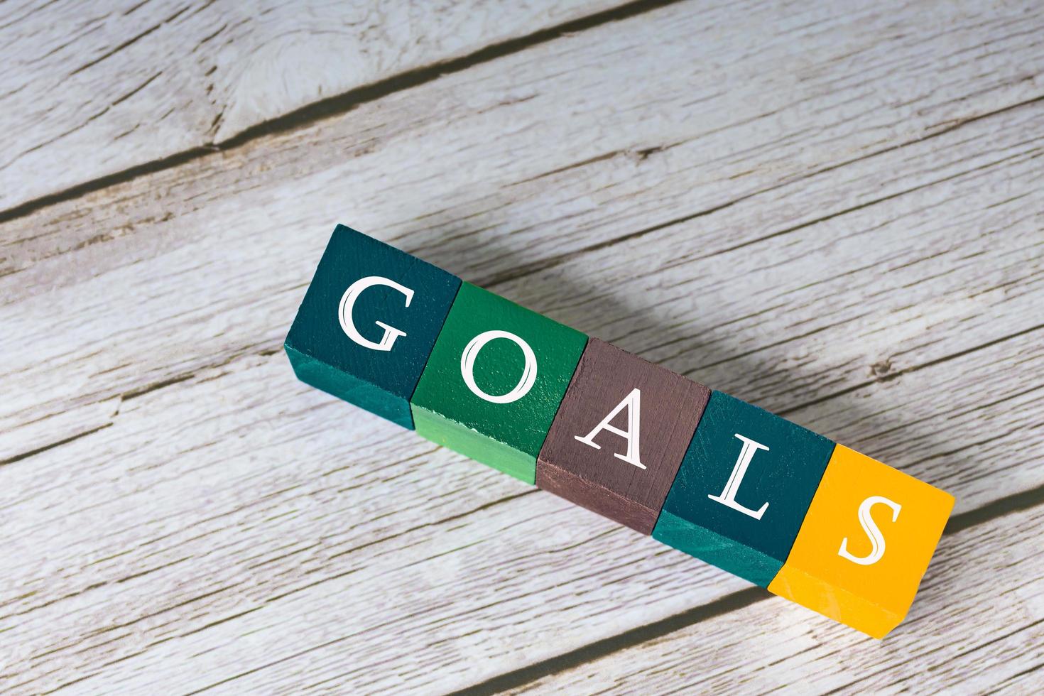 Goal word on colorful wooden cubes on wooden desk. photo