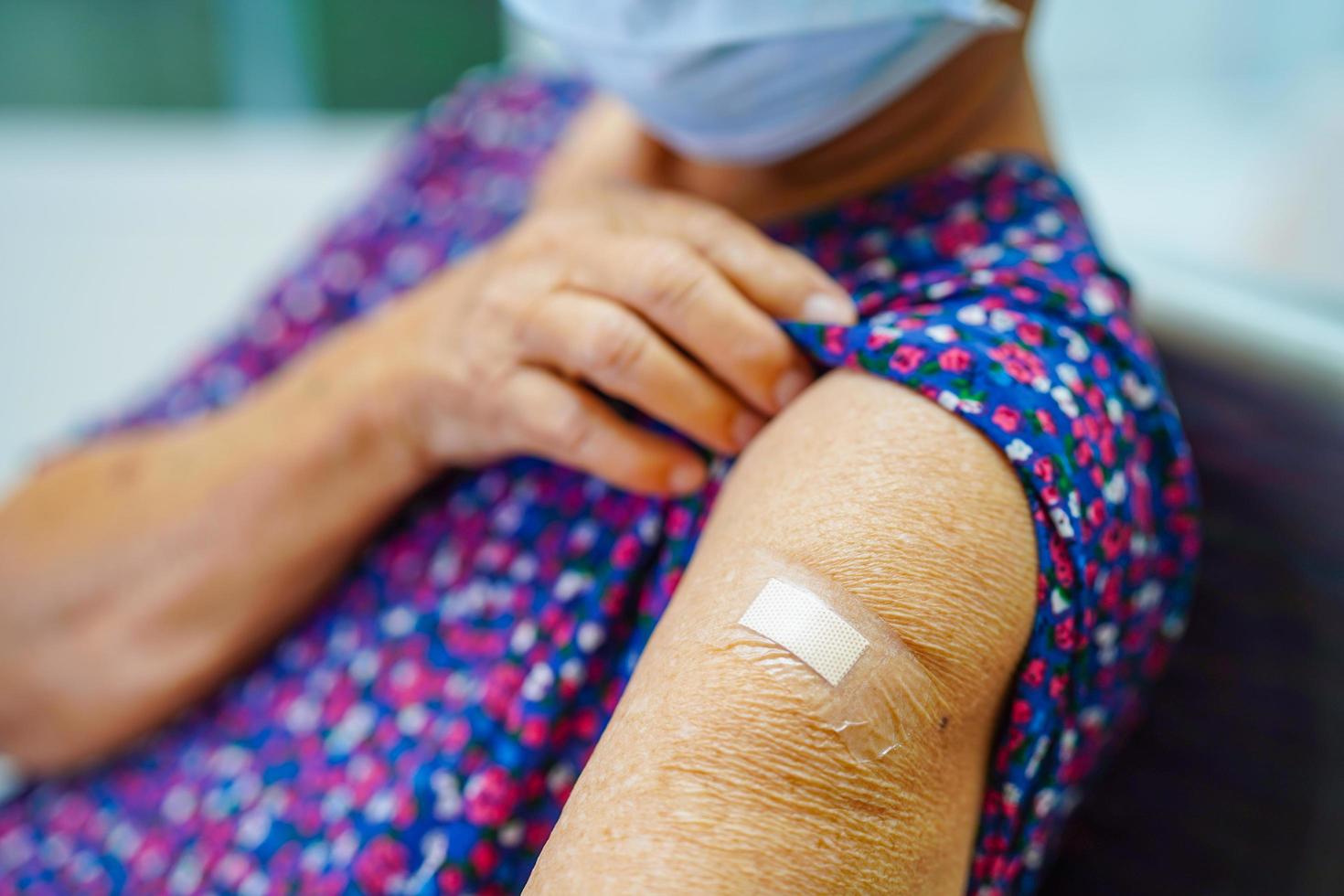 Asian elder senior woman getting vaccine for protect corona virus. photo