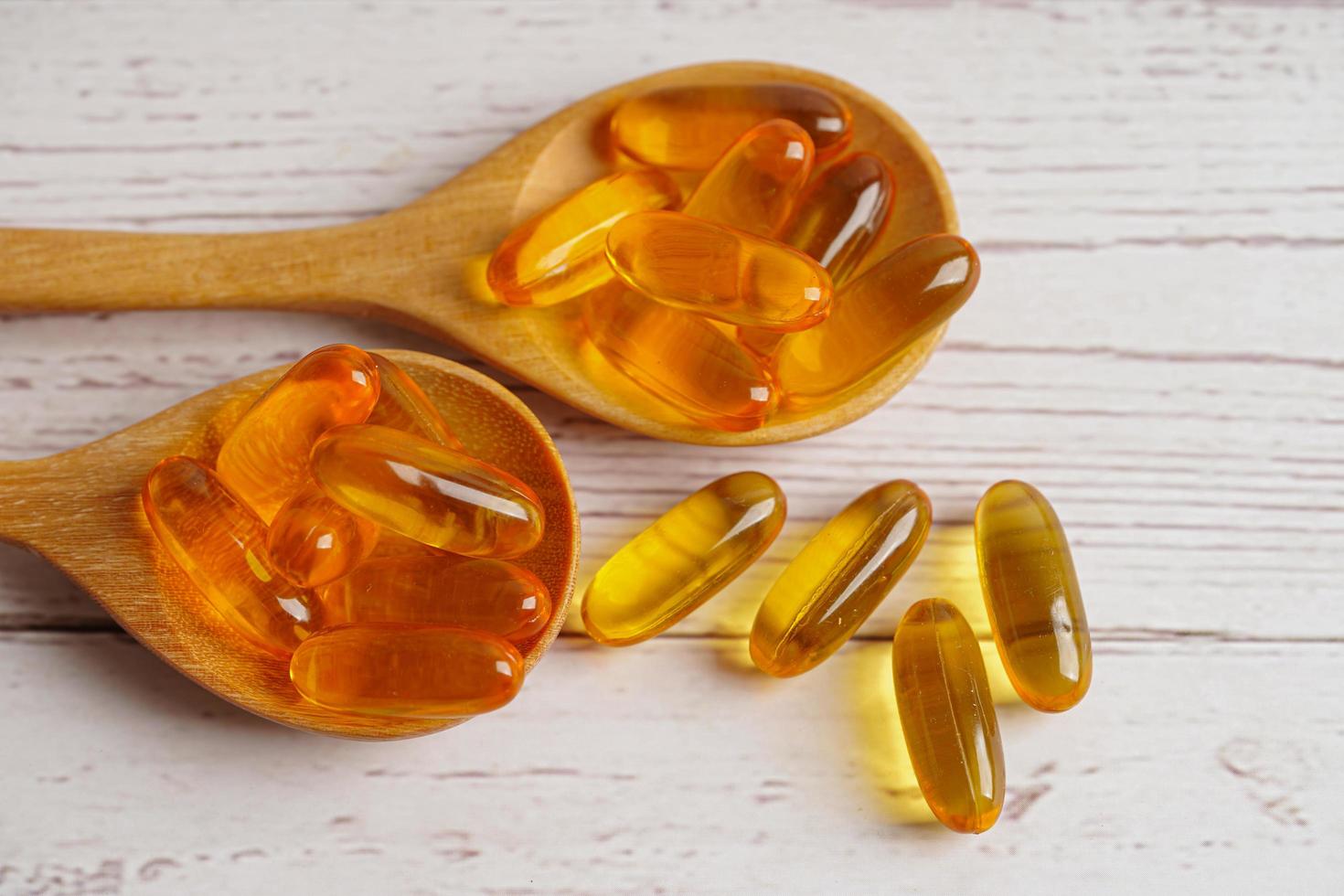 Fish oil or Cod liver oil gel in capsules with omega 3 vitamins, supplementary healthy food photo