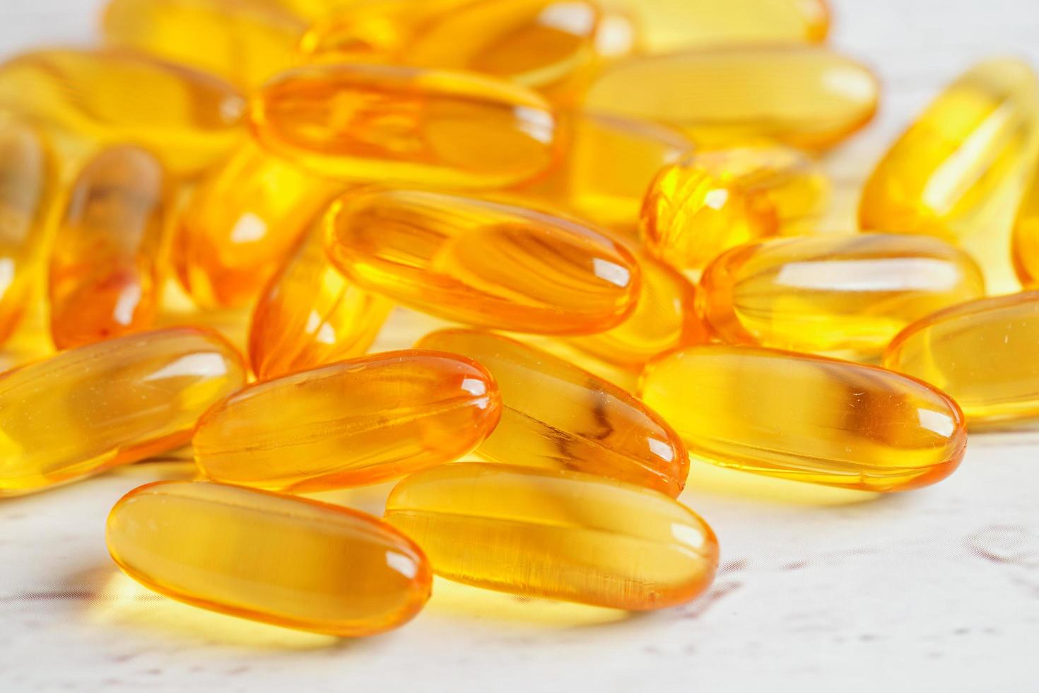 Fish oil or Cod liver oil gel in capsules with omega 3 vitamins, supplementary healthy food photo