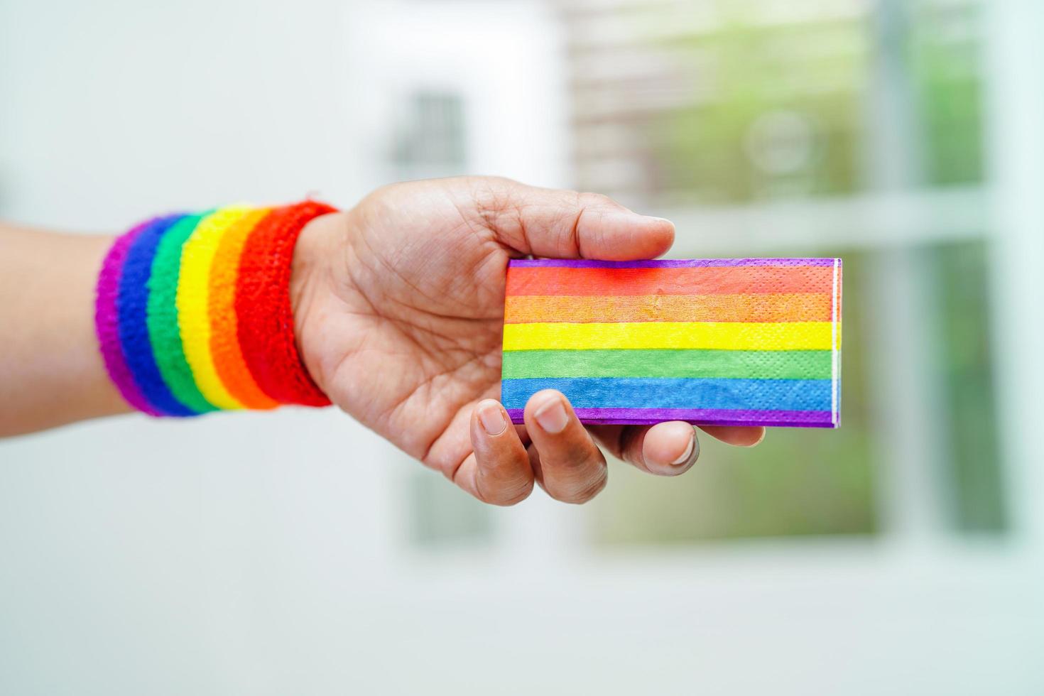 Asian woman with rainbow flag, LGBT symbol rights and gender equality, LGBT Pride Month in June, LGBTQ, LGBTI, LGBTQA, LGBTQIA photo