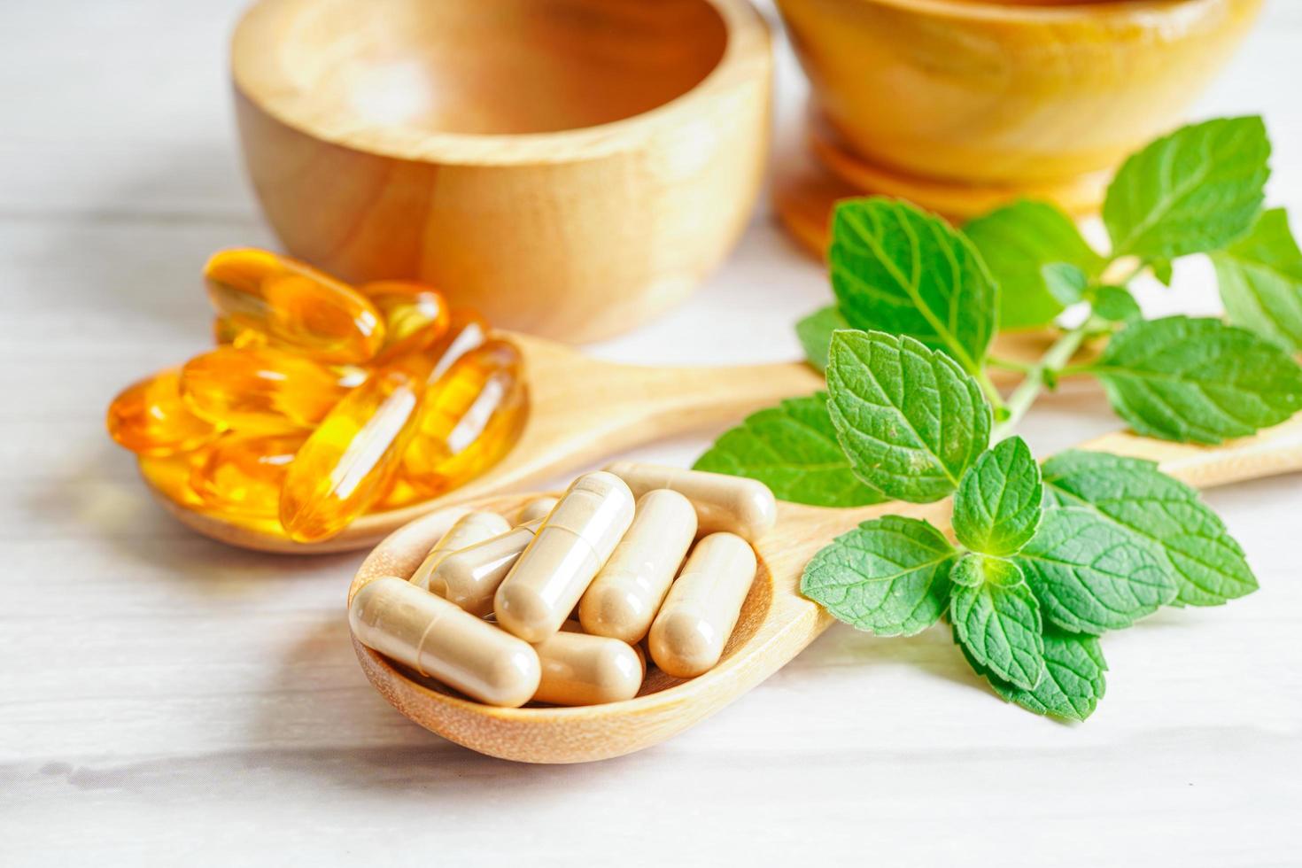 Alternative medicine herbal organic capsule with vitamin E omega 3 fish oil, mineral, drug with herbs leaf natural supplements for healthy good life. photo