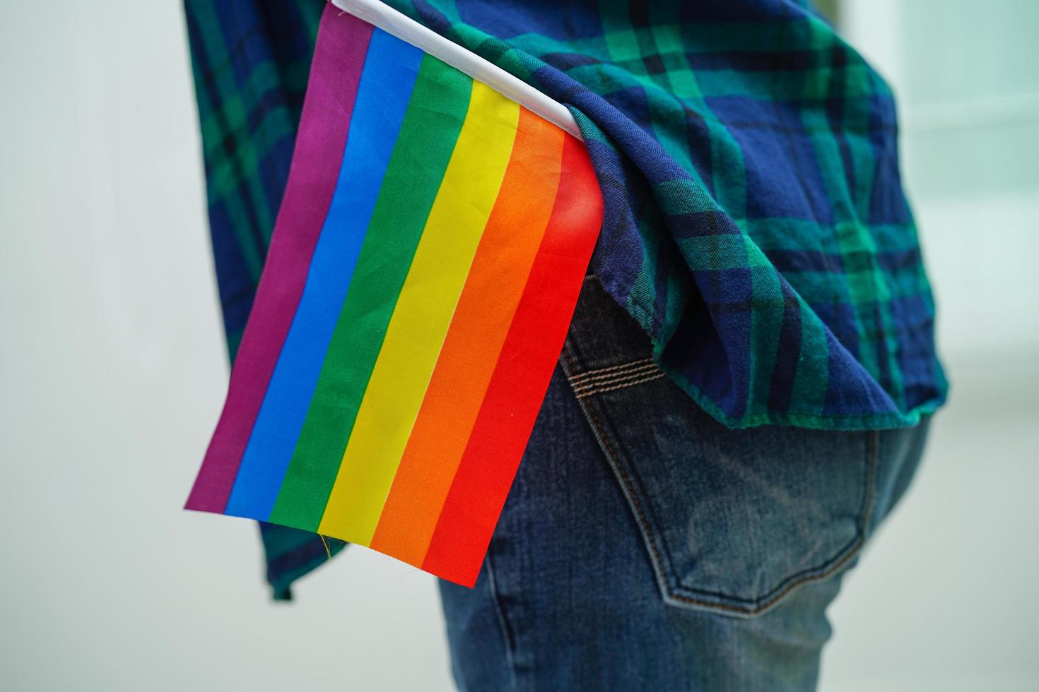 Asian woman with rainbow flag, LGBT symbol rights and gender equality, LGBT Pride Month in June. photo