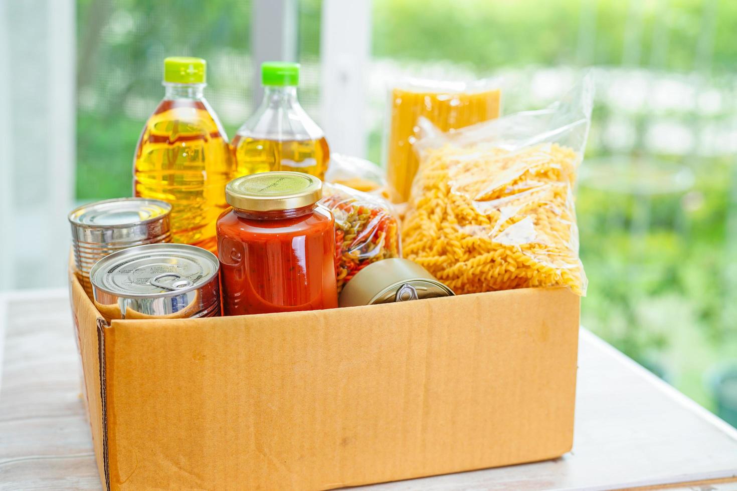 Foodstuffs in donation box for volunteer. photo