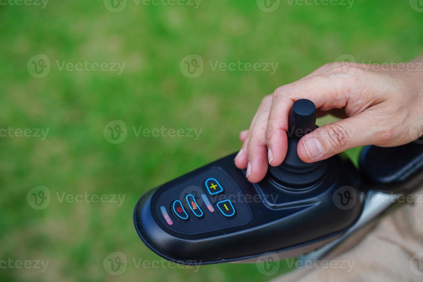 Asian elderly woman disability patient sitting on electric wheelchair in park, medical concept. photo
