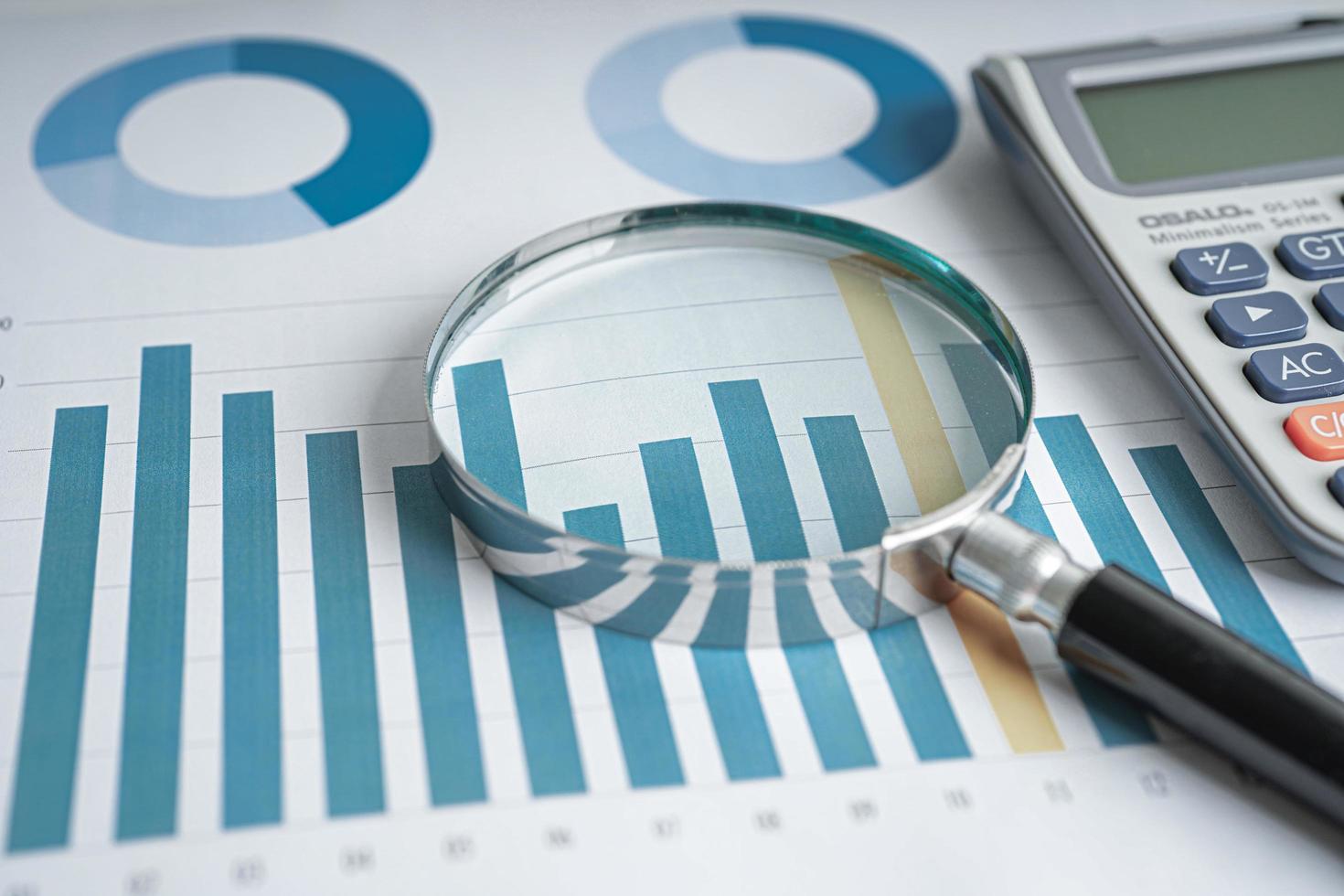 Magnifying glass on charts graphs paper. Financial development, Banking Account, Statistics, Investment Analytic research data economy. photo