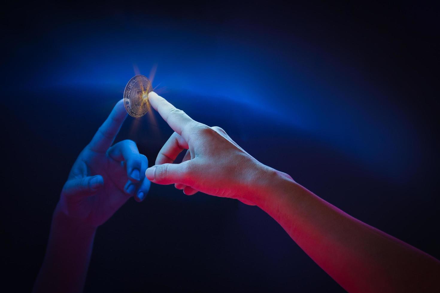 Hand touch virtual globe and bitcoin crypto currency investment. photo