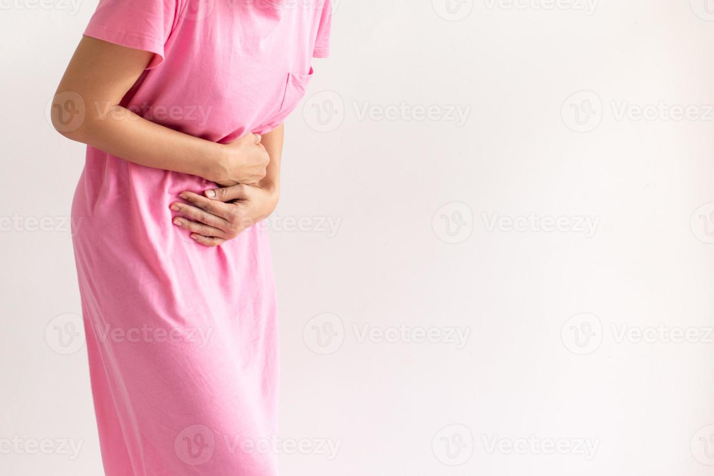 Woman suffering from stomach pain isolated in white background. photo