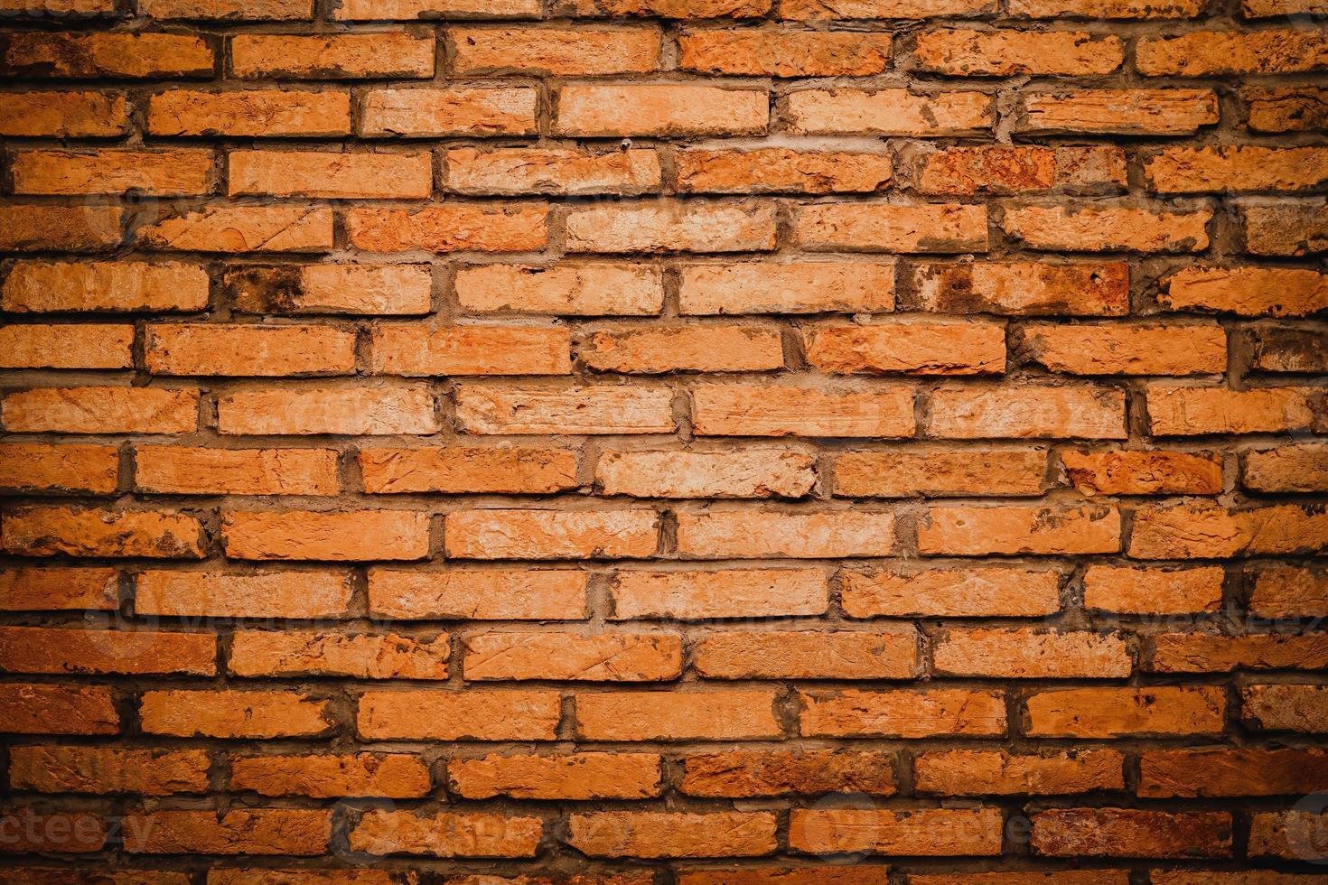 Red brick wall. Texture of old brown and red brick wall background. Fragment of red brick wall closeup. The structure of the background. Template for an inscription. Mockup for designs. photo