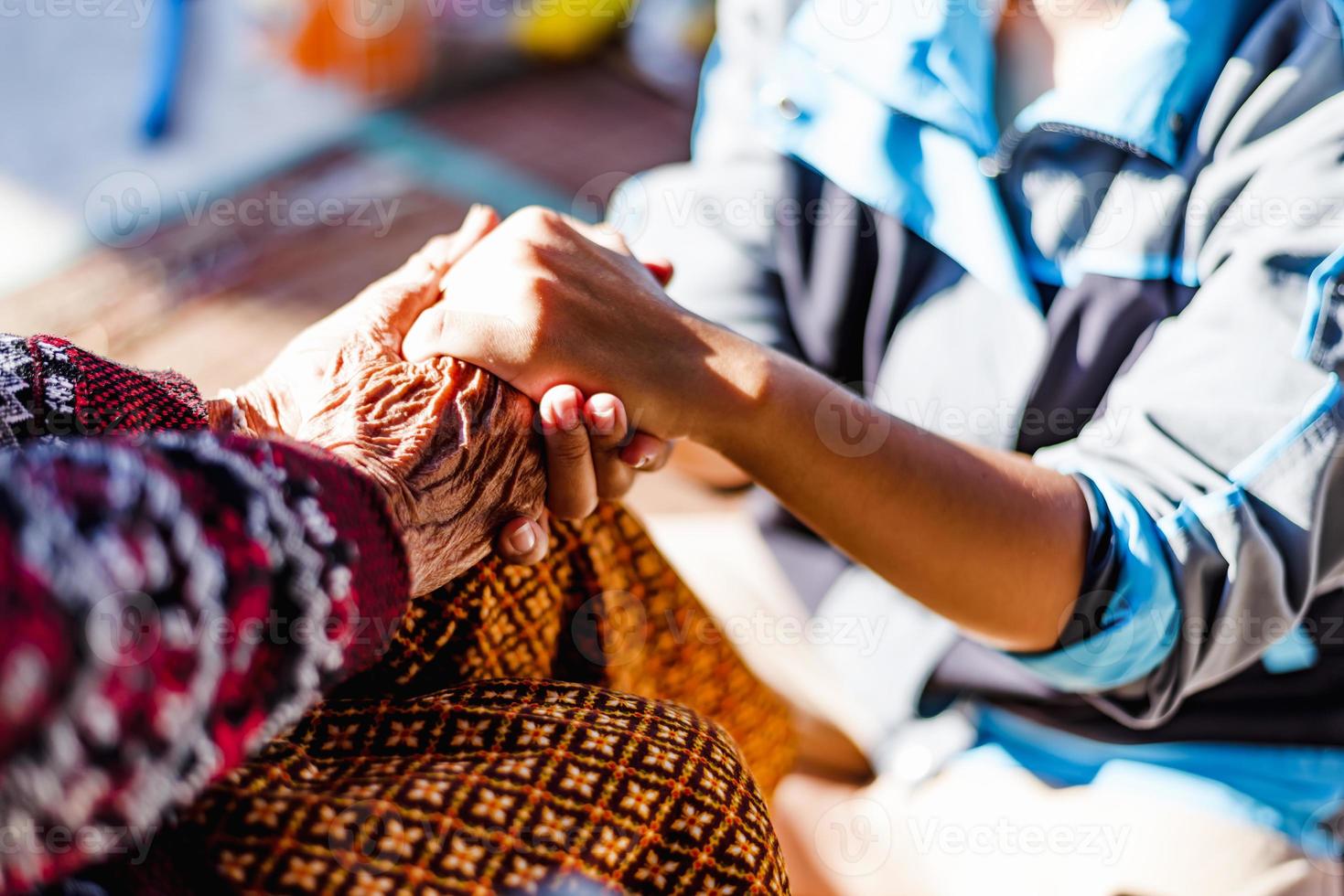 Close up hands of helping hands elderly home care. Mother and daughter. Mental health and elderly care concept photo