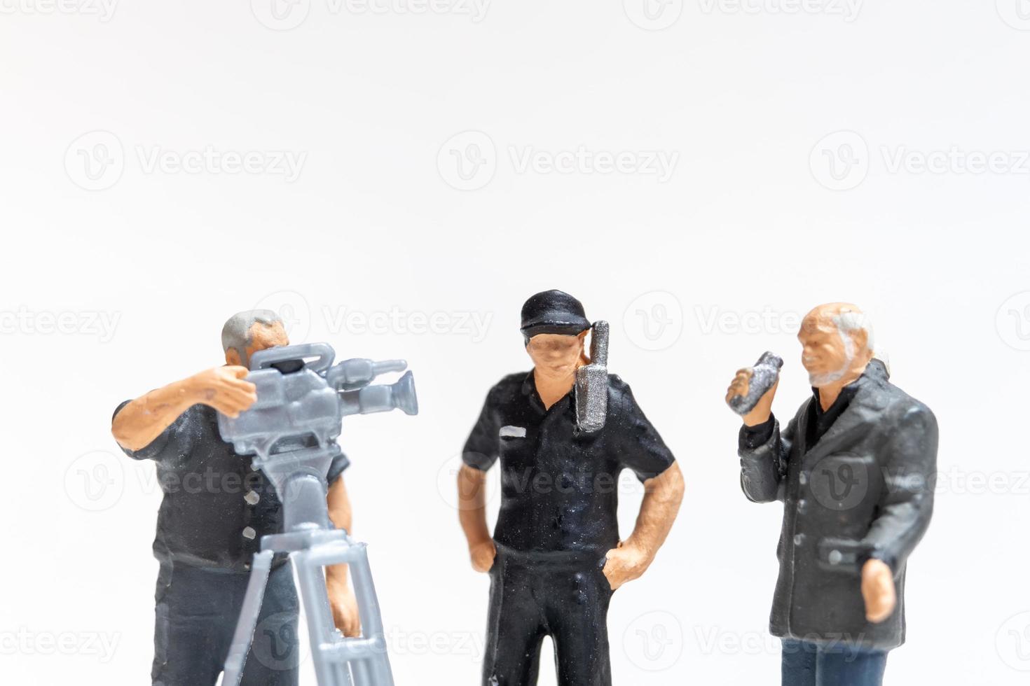 Miniature news reporter with microphone and cameraman interviewing police officers photo