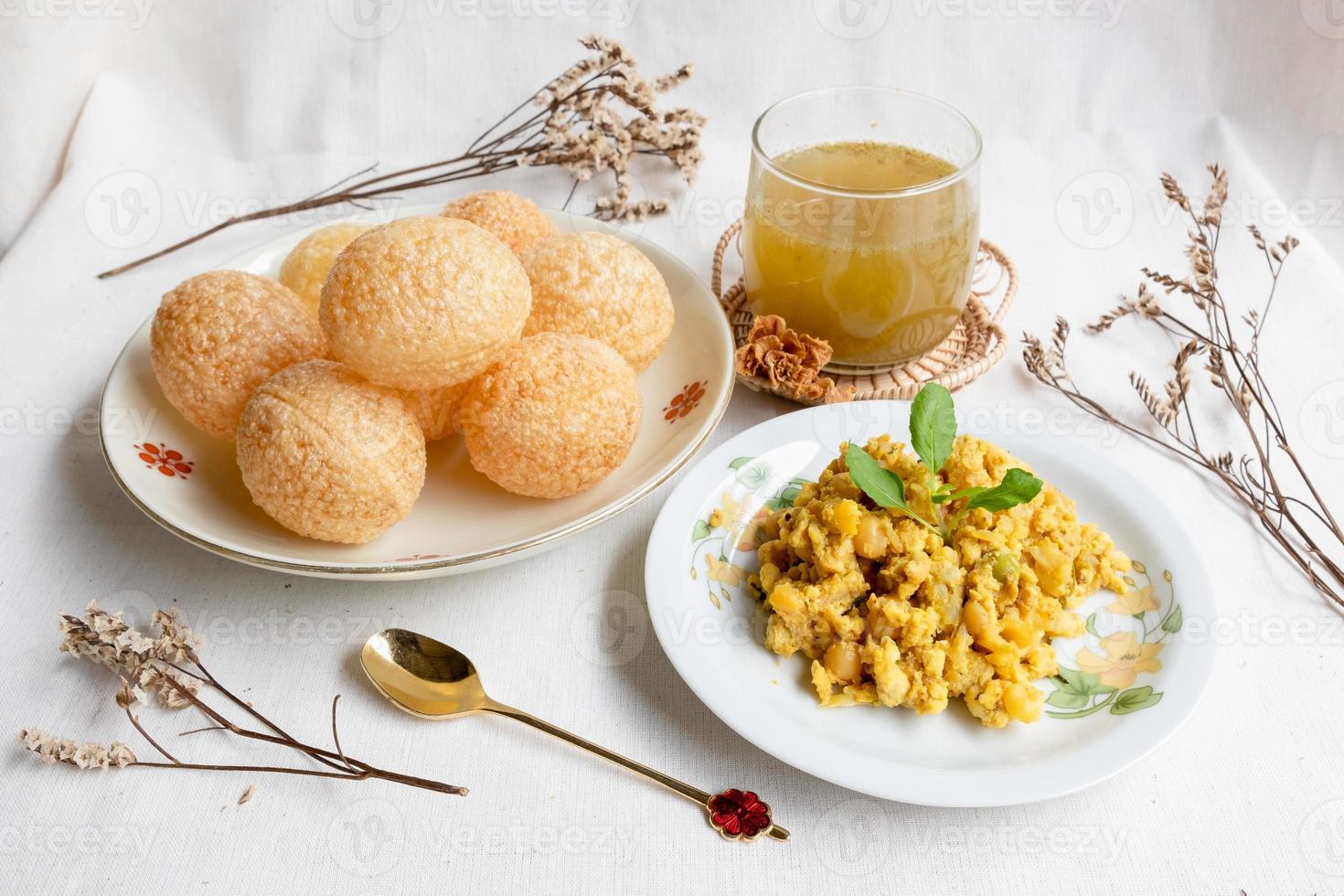 Homemade pani puri, Golgappa Indian snack on cotton calico background photo