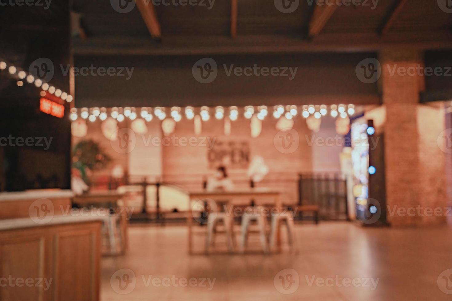 Movie theater entrance interior blur image use for background of business and cinema concept. Abstract blur people queuing to buy ticket at the counter and buy popcorn. photo