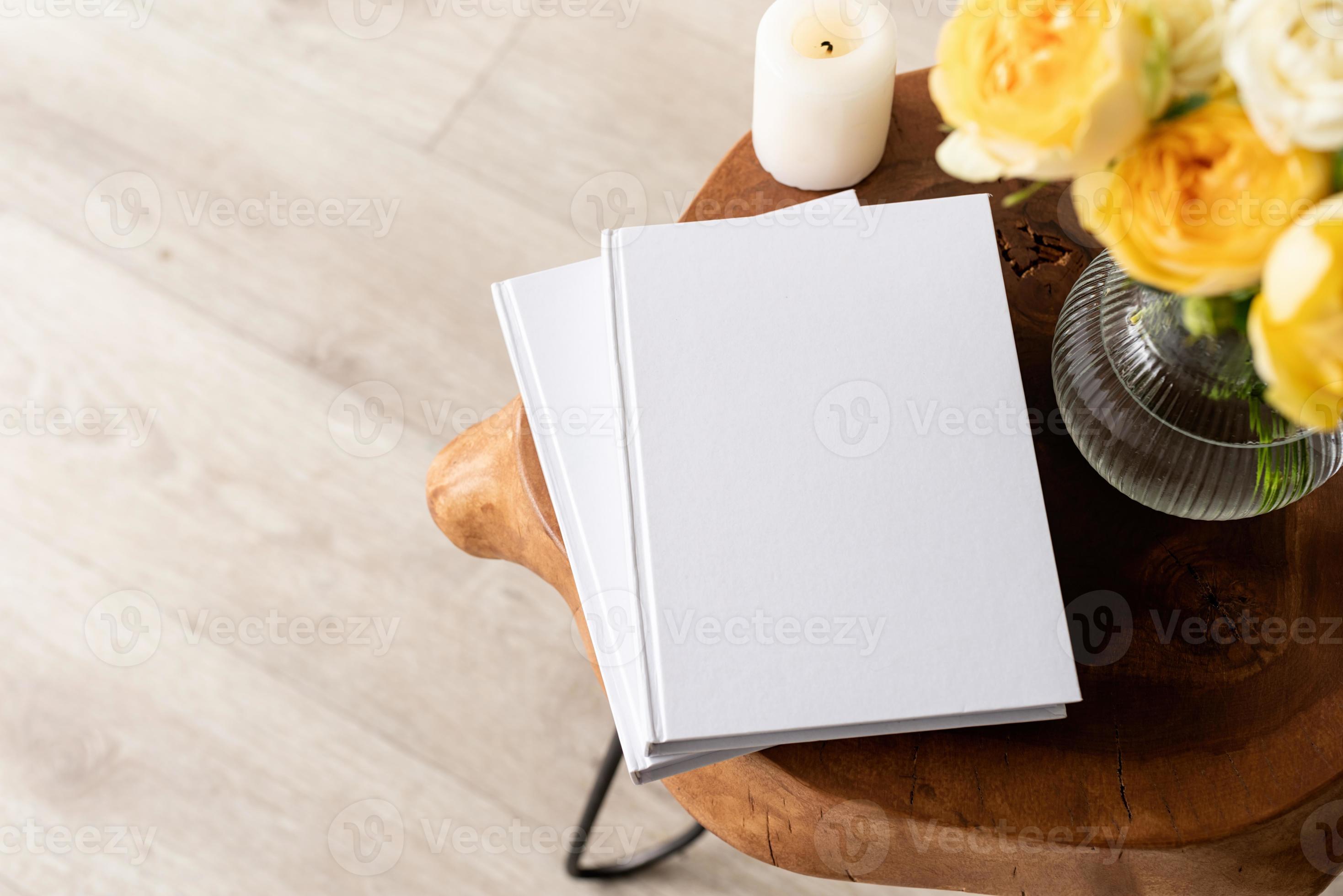 White book blank cover mockup on stylish wooden coffee table with roses
