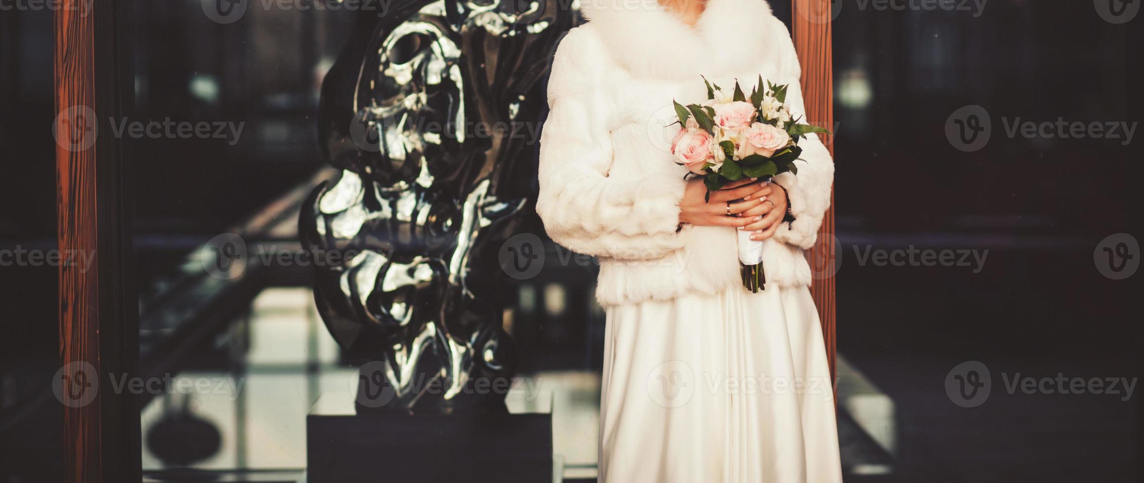 beautiful bride in a fur coat photo