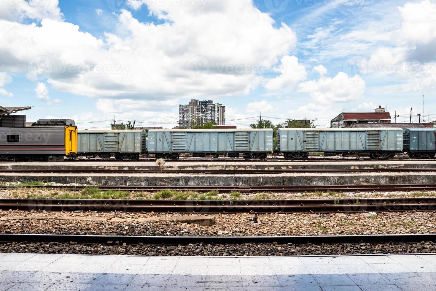 Railroad tracks of a railway station in Thailand and beautiful blue sky photo