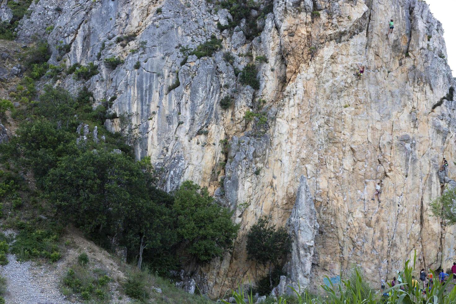 Crimea, Ukraine, July 25, 2021 - A group of children are engaged in rock climbing as a sport on the rocks in the Crimean mountains. photo