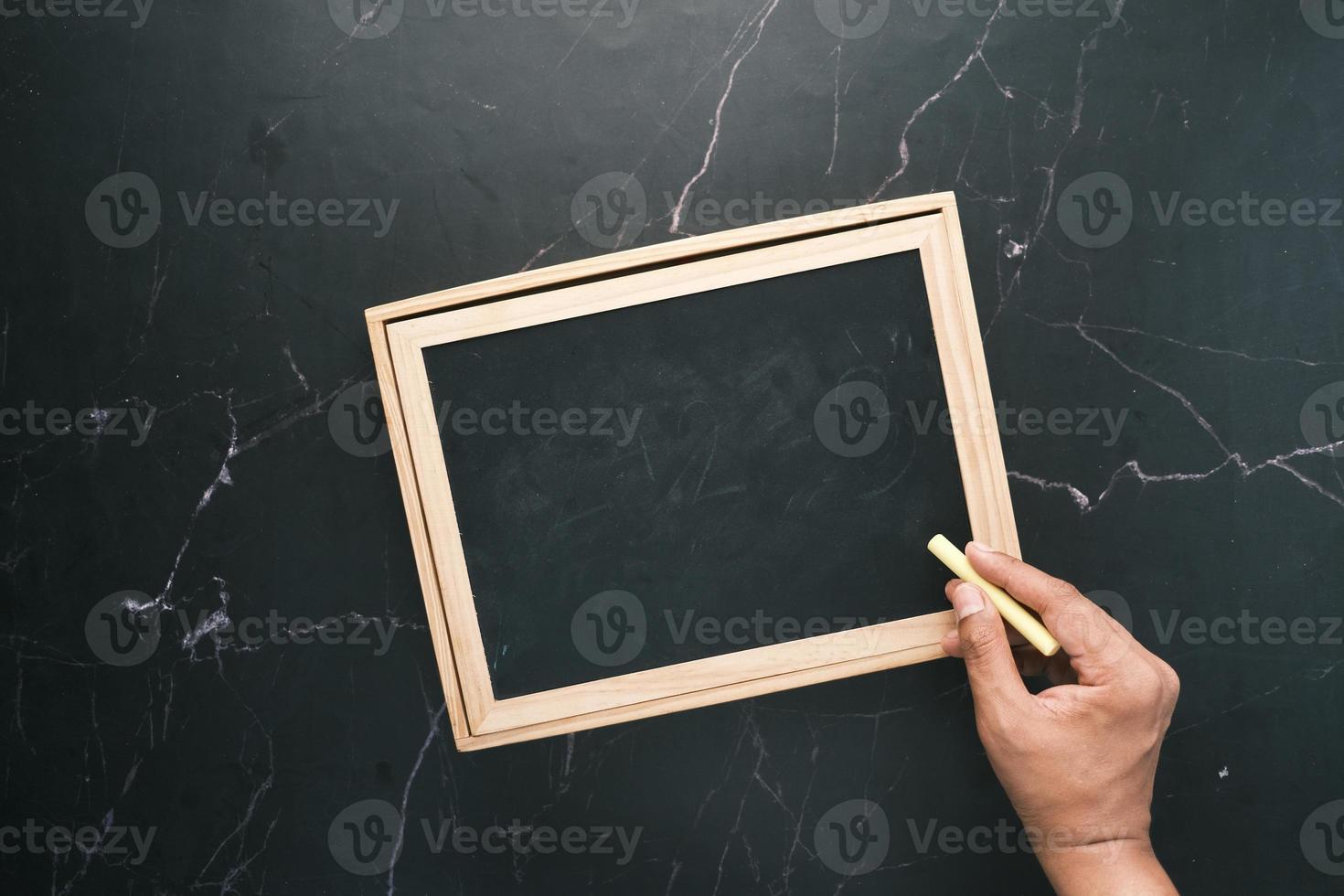 colorful chalk and chalkboard on black background photo