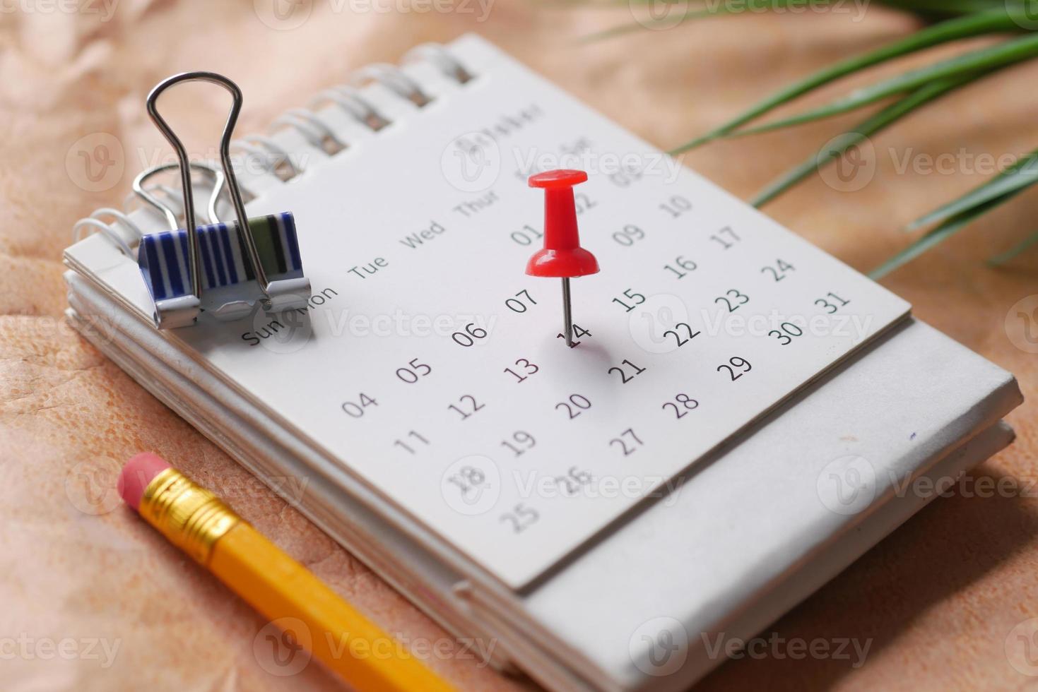 deadline concept with push pin on calendar date close up photo