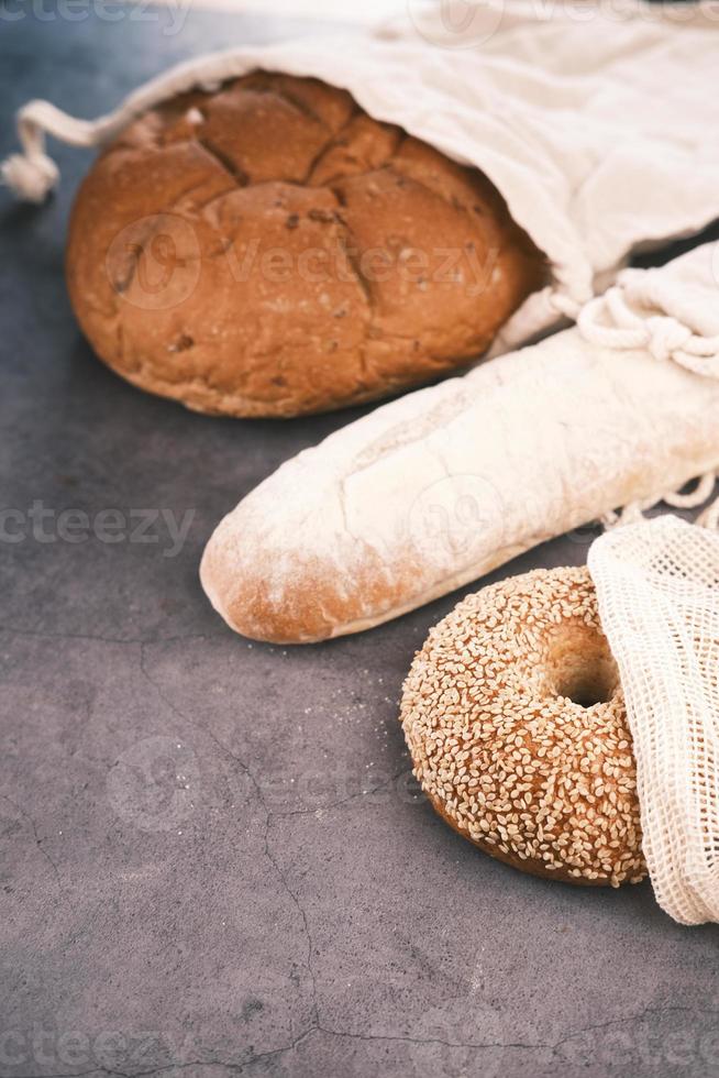 baked bread stored in a reusable linen bag . Eco friendly Zero waste concept.. photo