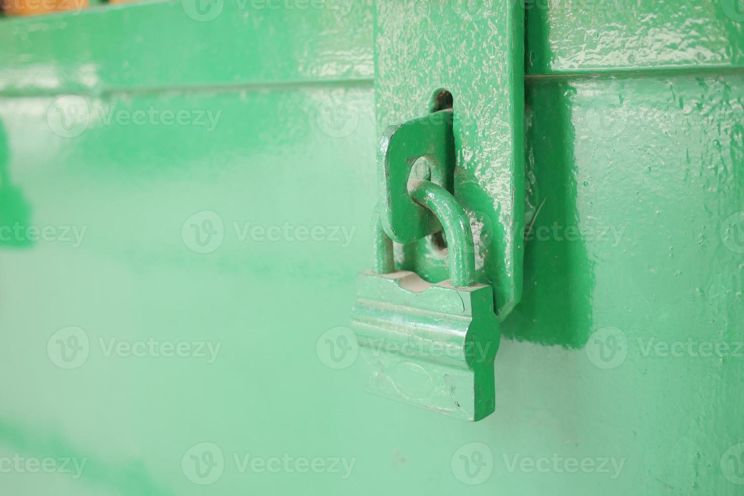 Padlock handing on a old door photo