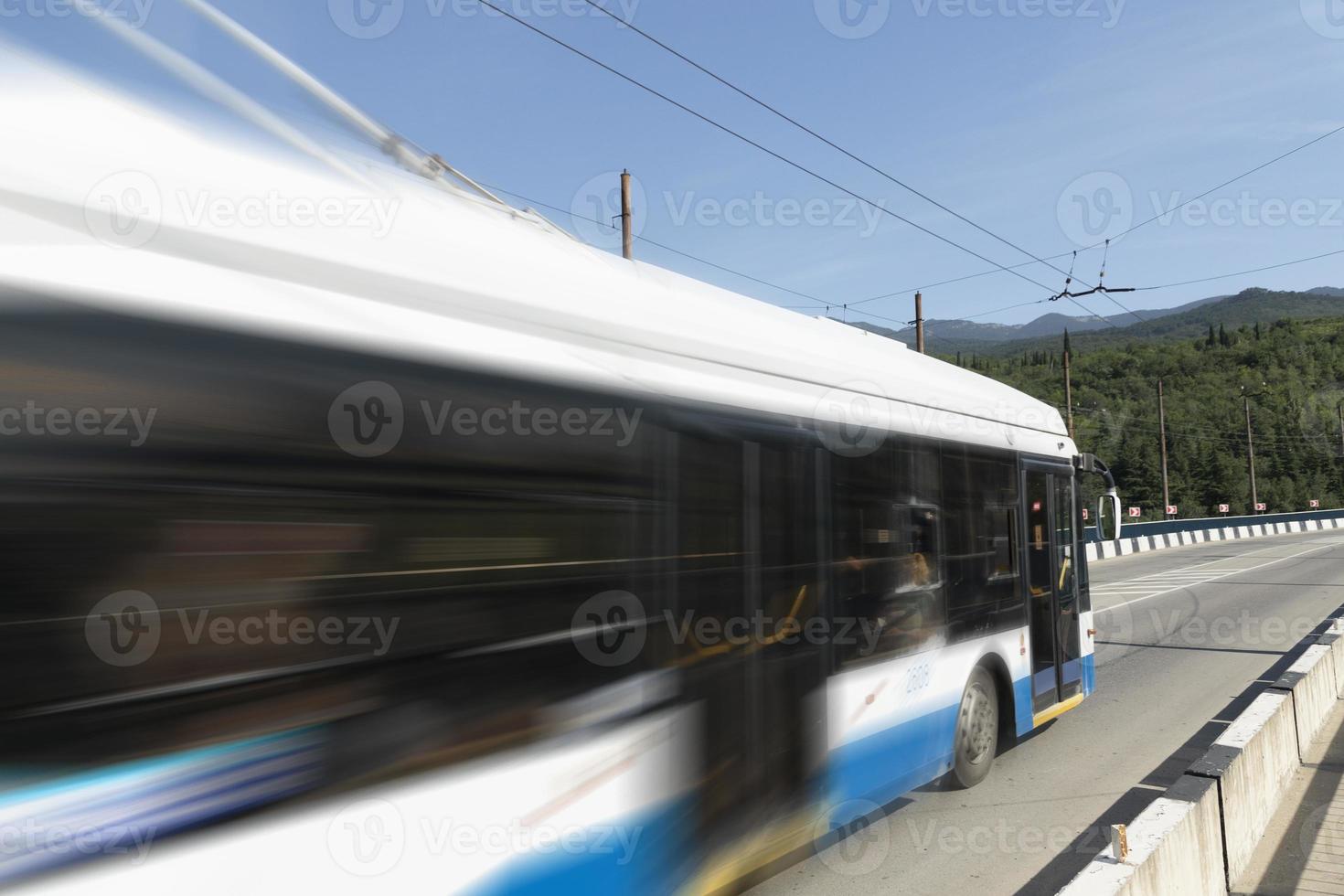 Modern trolleybus on a mountain road in the Crimea. Soft blurry focus. photo