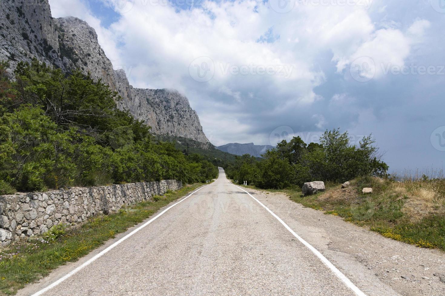 An old European road in the mountains along the rocks. Coast of the Black Sea. photo