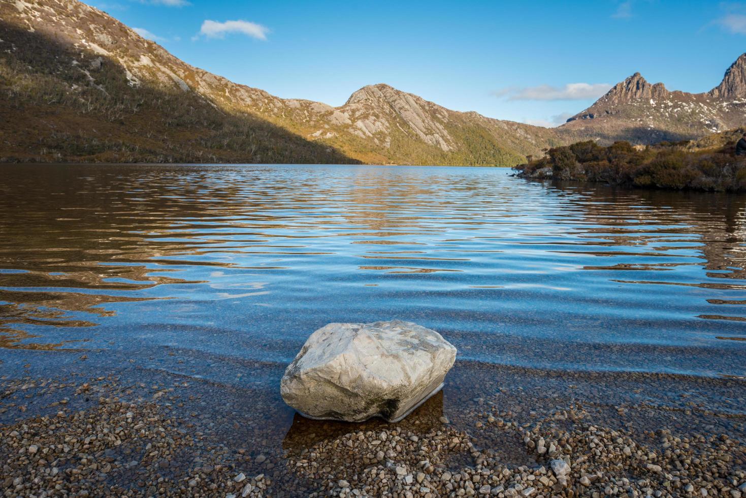 Rock on the edge of Dove lake in Cradle mountain national park, UNESCO world heritage sites of Tasmania state of Australia. photo