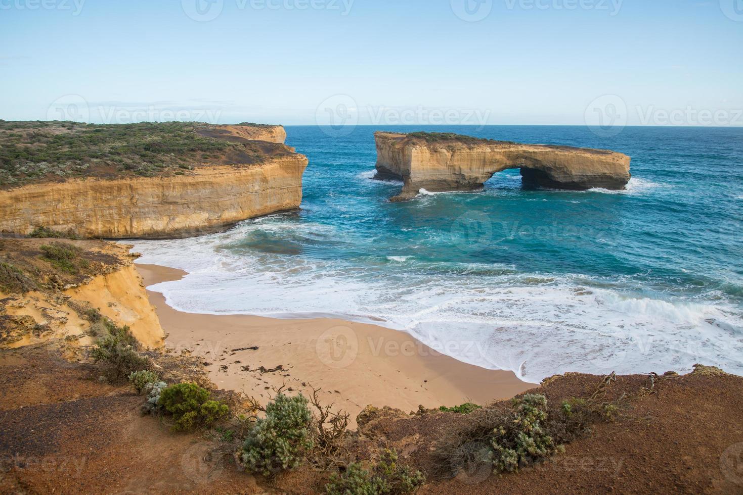View of London bridge an iconic rock formation and one of tourist attraction place in the Great Ocean Road of Victoria state, Australia. photo