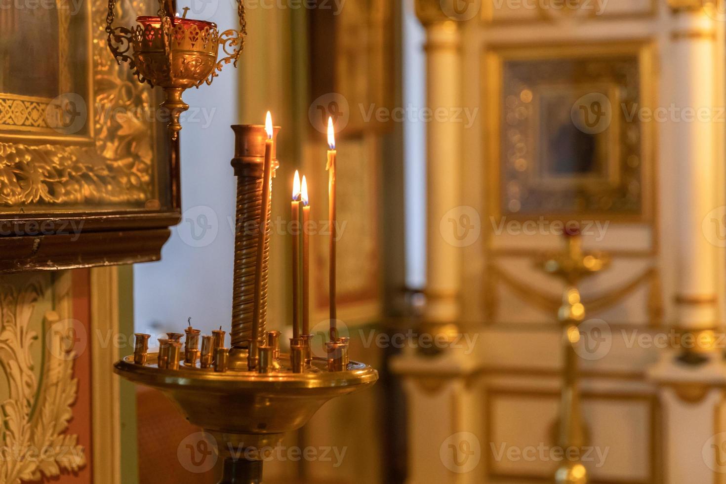 Orthodox Church. Christianity. Festive interior decoration with burning candles and icon in traditional Orthodox Church on Easter Eve or Christmas. Religion faith pray symbol. photo