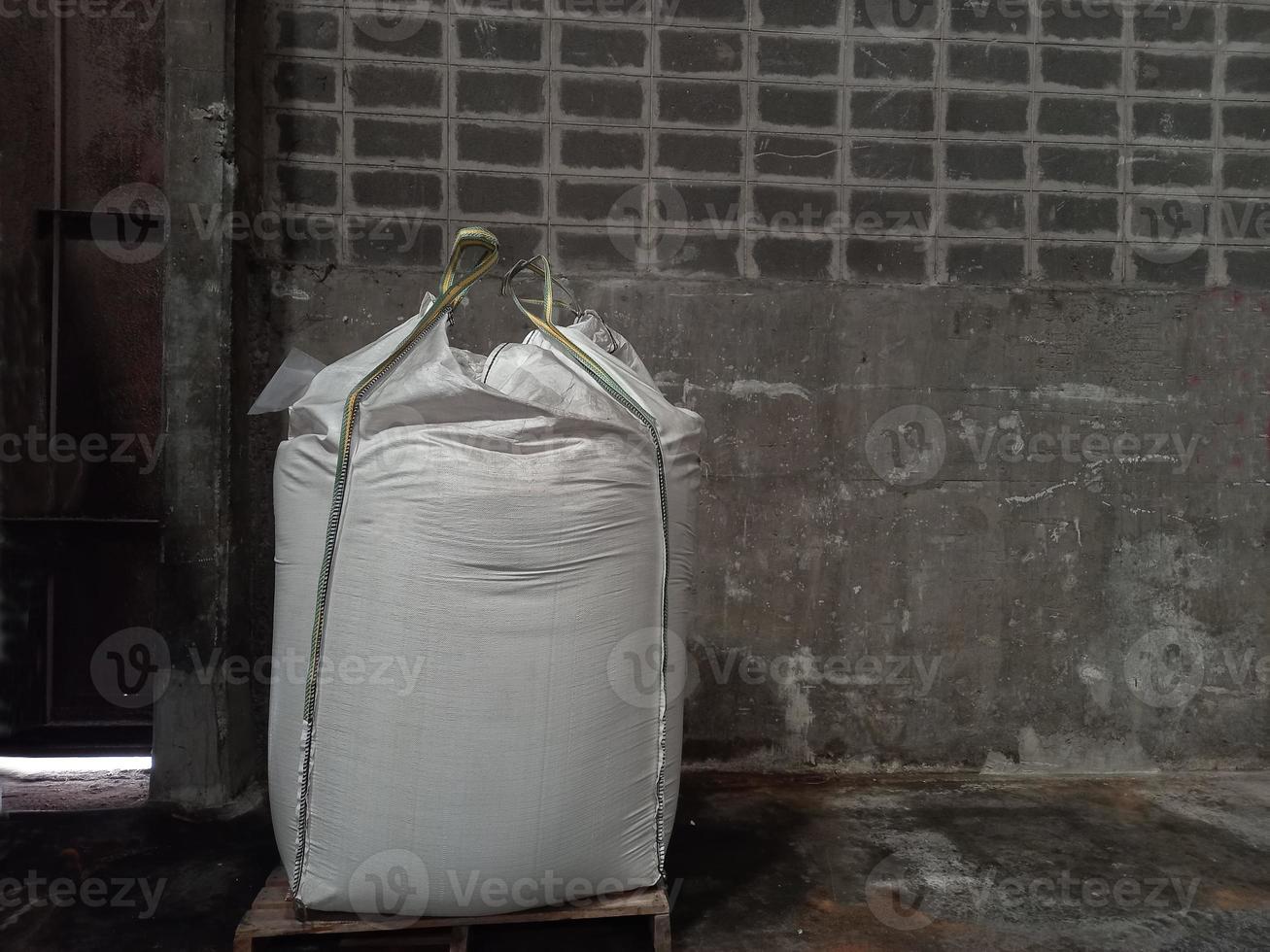 Large jumbo hemp sack White, packed with chemical fertilizer, rice, sugar, placed on a wooden pallet waiting to be delivered to the customer photo