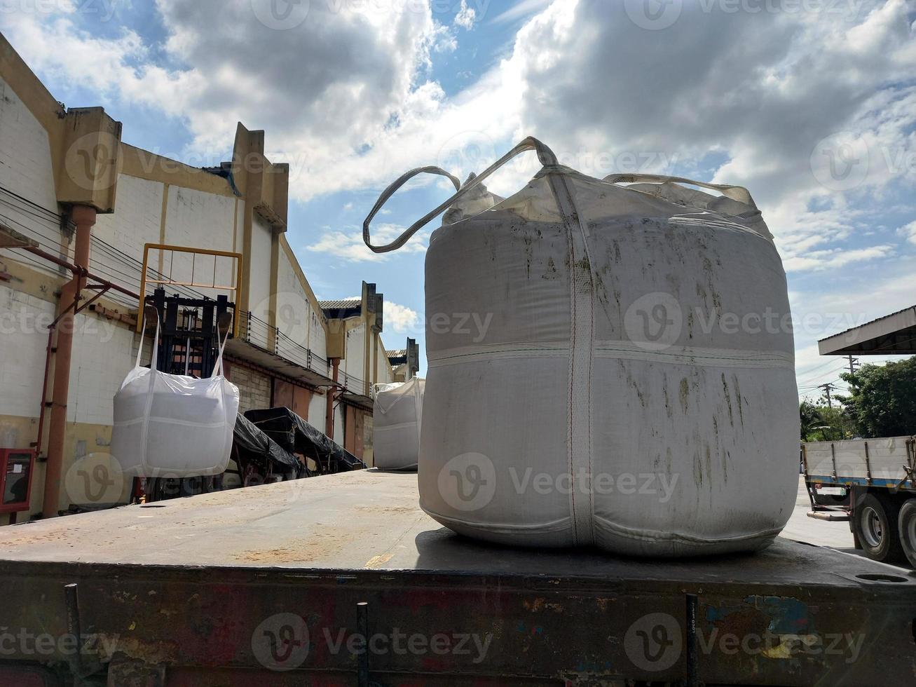 Large jumbo hemp sack White, packed with chemical fertilizer, rice, sugar, placed on a wooden pallet waiting to be delivered to the customer photo